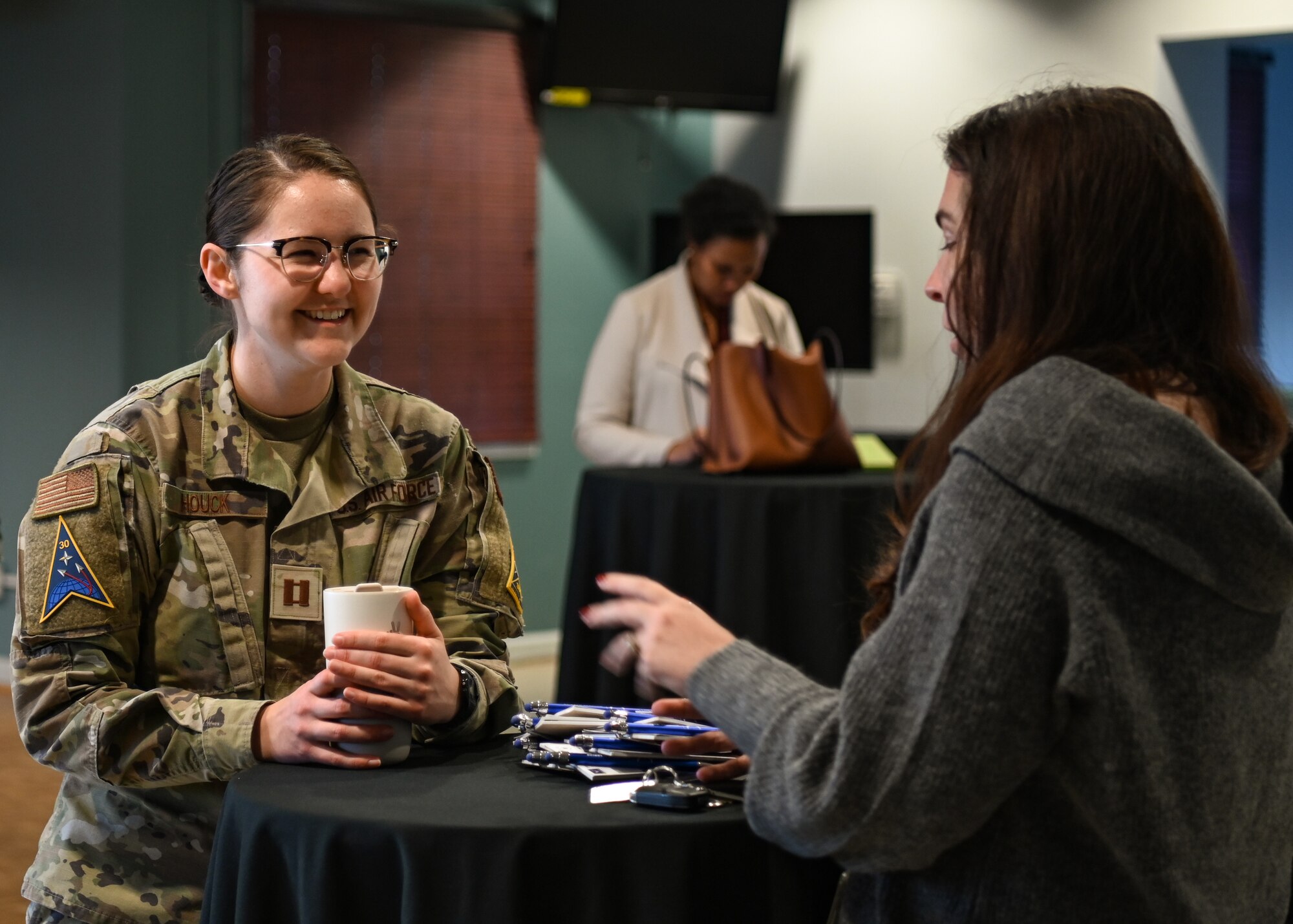 A Space Launch Delta 30 Judge Advocate assistant staff judge advocate, shares information with a guest during the Women of Vandenberg Empowerment Network hosted a speed networking event at Vandenberg Space Force Base.