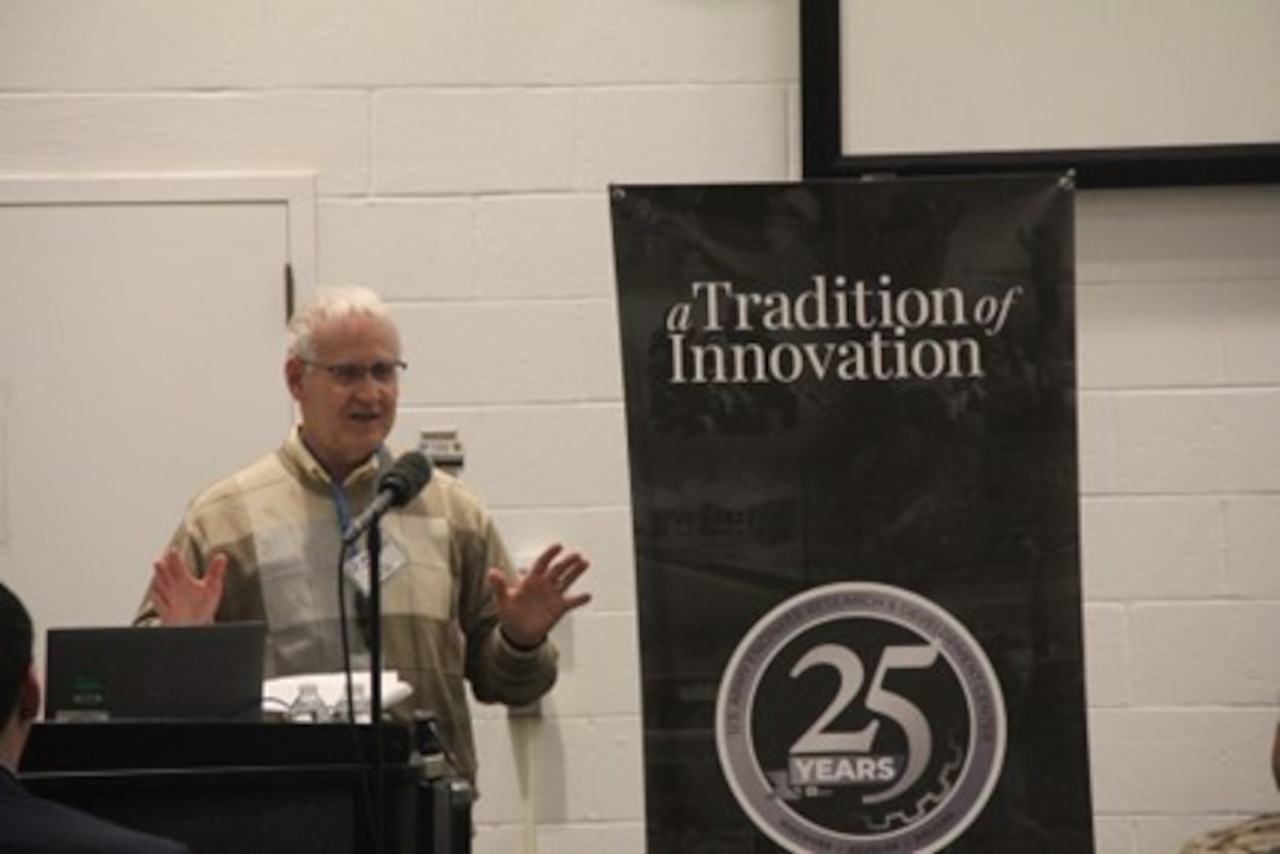 A person speaks from a podium.