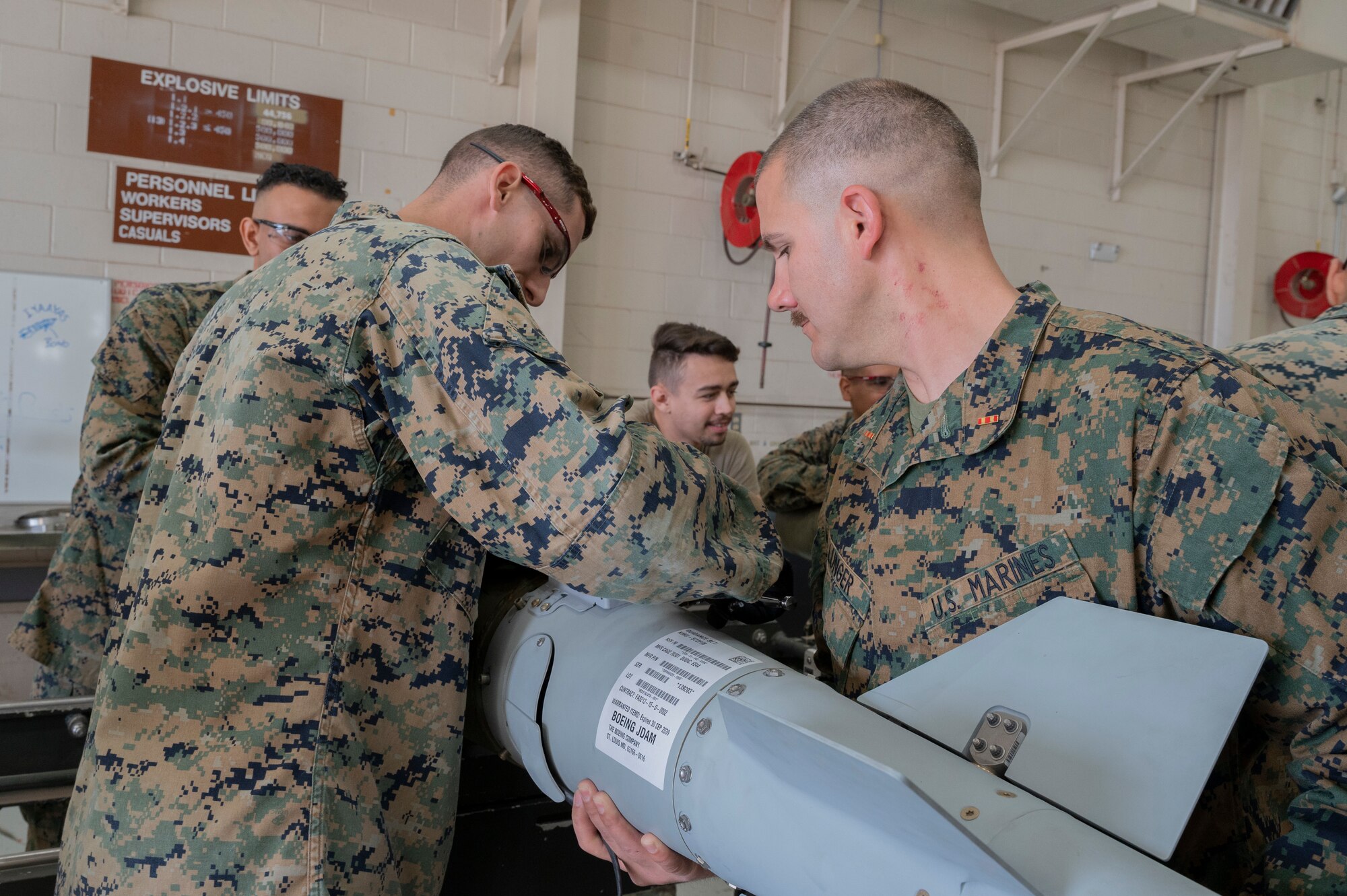 Airmen from the 7th Munitions Squadron and Detachment 1, 4th Combat Logistics Battalion 453 Marines build GBUs during a bomb building event at Dyess Air Force Base, Texas, Dec. 12, 2023. The 7th MUNS Conventional Maintenance section showcased how working as a team not only creates a more lethal and ready B-1B force but also bridges the gap between different U.S. military services. (U.S. Air Force photo by Airman 1st Class Alondra Cristobal Hernandez)