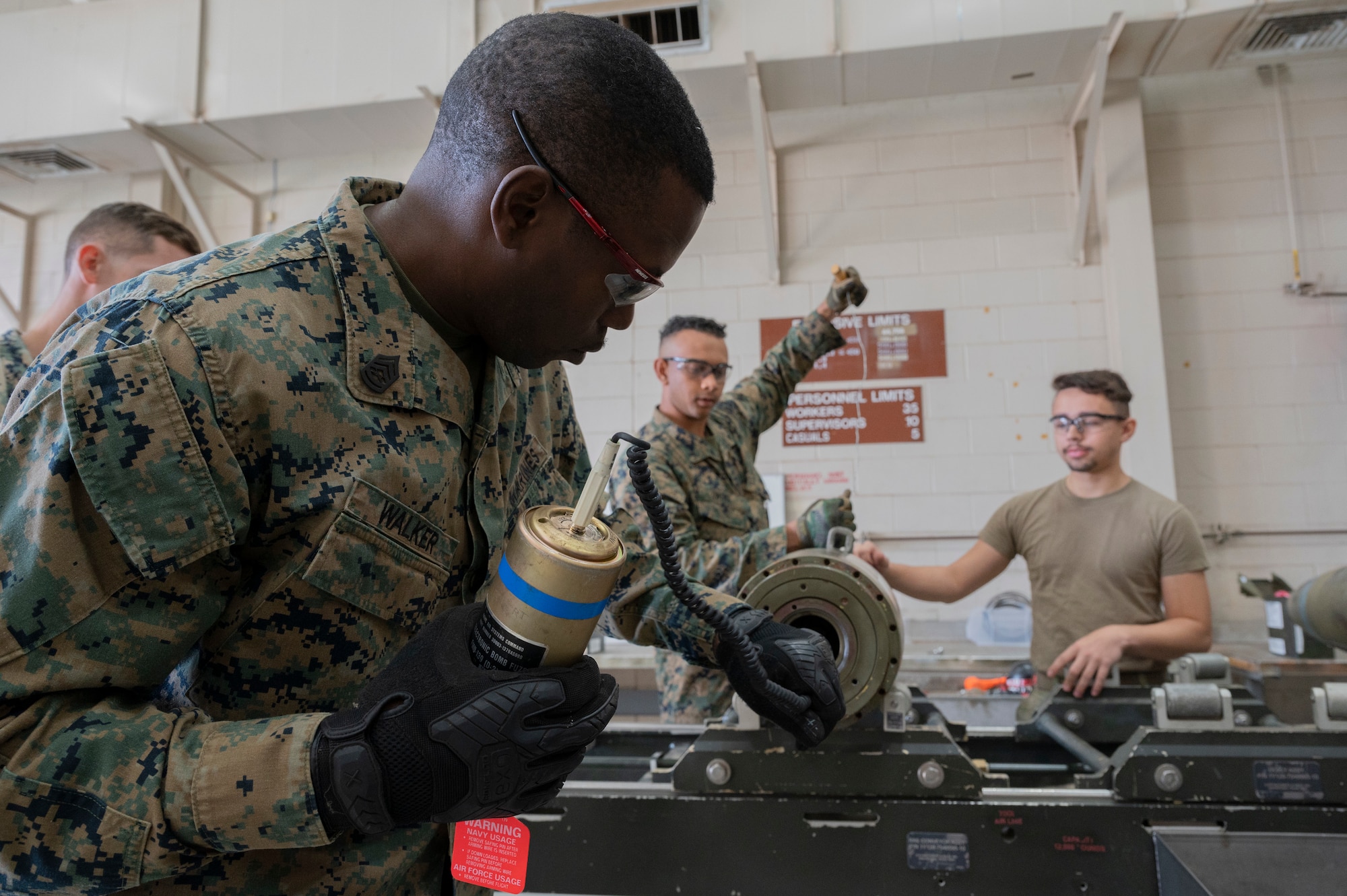 Airmen from the 7th Munitions Squadron and Detachment 1, 4th Combat Logistics Battalion 453 Marines build GBUs during a bomb building event at Dyess Air Force Base, Texas, Dec. 12, 2023. The 7th MUNS Conventional Maintenance section hosted a bomb build for Dyess Marine Corps personnel to network and foster relationships within joint services on base. (U.S. Air Force photo by Airman 1st Class Alondra Cristobal Hernandez)