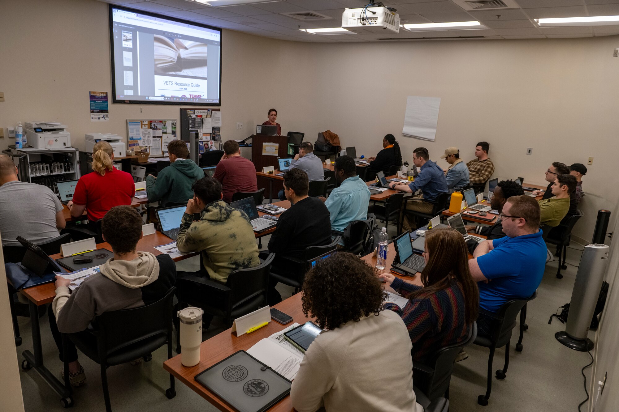 A photo of a classroom full of people.