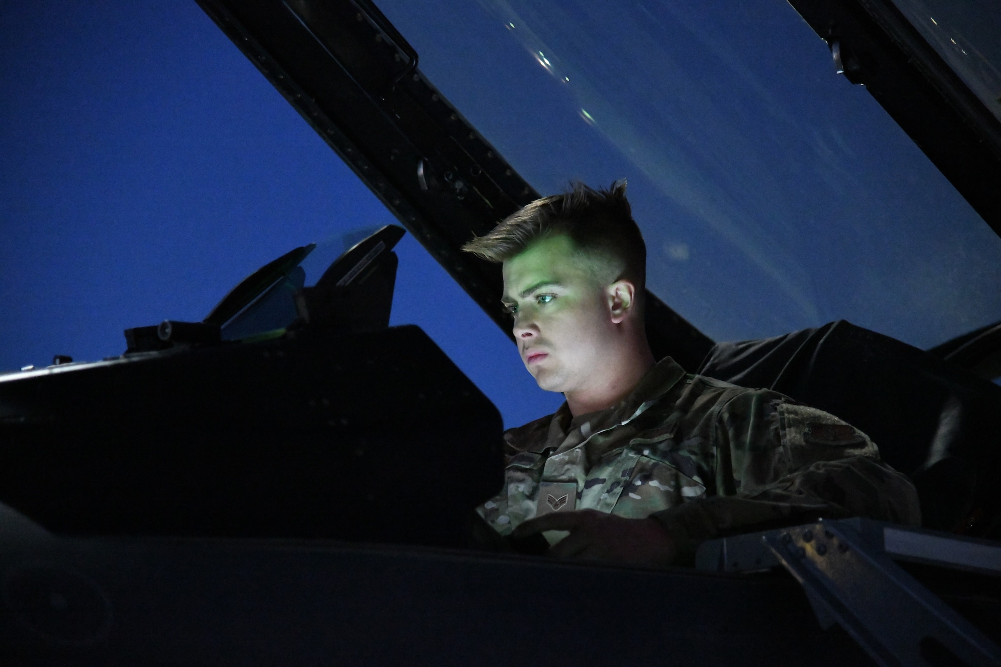 F-16 Fighter Aircraft Integrated Avionics Specialist, Staff Sgt. Isaak Blue, performs an operational check on an F-16 Fighting Falcon during a training deployment at Nellis Air Force Base, Nevada on Feb. 9, 2022.