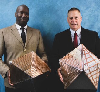 Two men hold their invention.