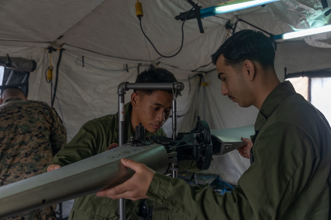 A U.S. Marine with Marine Aviation Logistics Squadron (MALS) 36 conducts maintenance on a rotar blade during Stand-in Force Exercise (SIFEX) 24 at Camp Hansen, Okinawa, Japan, Dec. 6, 2023. SIFEX 24 is a division-level exercise involving all elements of the Marine Air-Ground Task Force focused on strengthening multi-domain awareness, maneuver, and fires across a distributed maritime environment. This exercise serves as a rehearsal for rapidly projecting combat power in defense of allies and partners in the region. (U.S Marine Corps photo by Cpl. Emily Weiss)