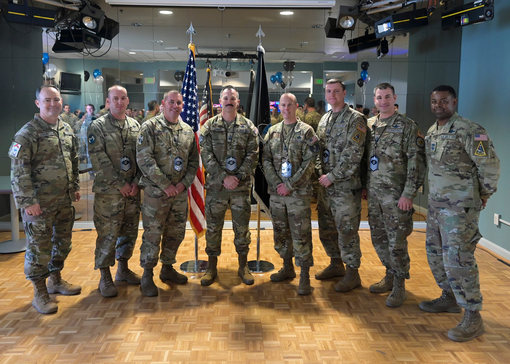 A group of people all stand shoulder to shoulder for a group photo.