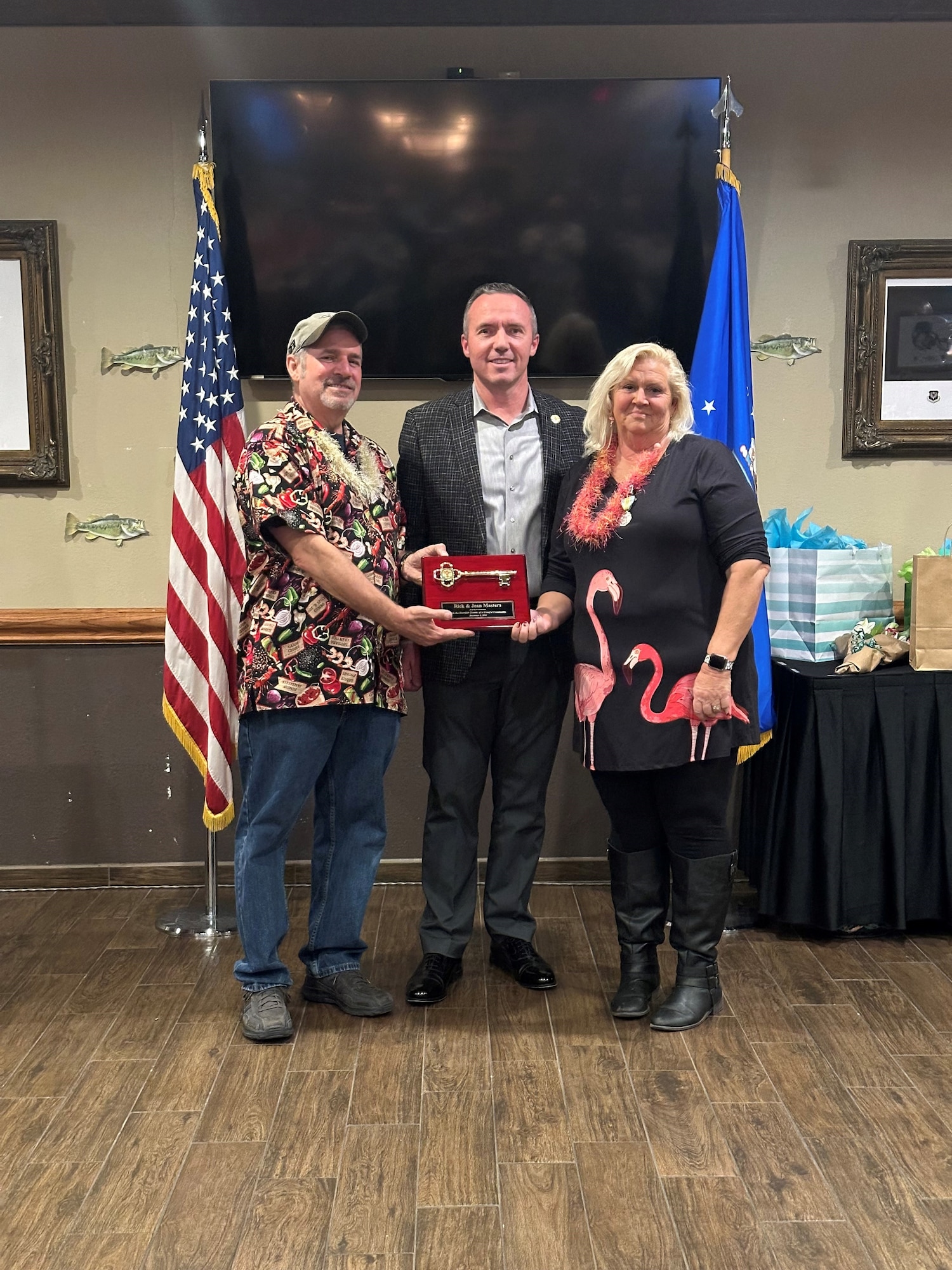 Mike Morris, Mayor of Clovis, MM., presents Rick and Jean Masters with a key to the city of Clovis during the Masters’ going away, Dec. 5, 2023, at the Landing Zone, Cannon Air Force Base, N.M. Rick and Jean have been instrumental in growing the community of Clovis, Portales, and Cannon AFB in their 16 years here. (Courtesy Photo)
