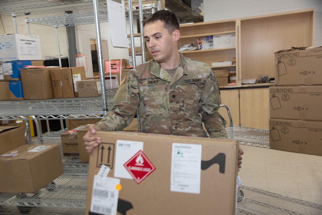 Soldier moves box.