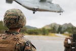 A U.S. Marine with Marine Aviation Logistics Squadron 36 observes the takeoff of an MV-22B Osprey assigned to Marine Medium Tiltrotor Squadron 262 during Stand-in Force Exercise 24 at Camp Hansen, Okinawa, Japan, Dec. 1, 2023. SIFEX 24 is a division-level exercise involving all elements of the Marine Air-Ground Task Force focused on strengthening multi-domain awareness, maneuver, and fires across a distributed airtime environment.