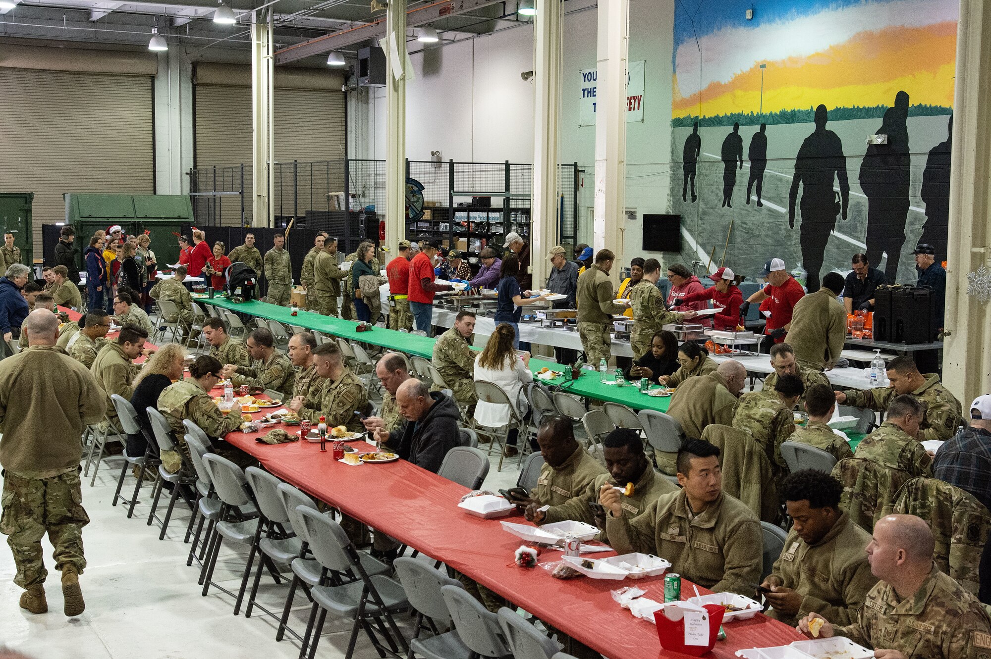 In its 21st year, Operation Feed the Troops volunteers served more than 800 meals to active duty, Reserve and civilians, and their family members during two different meals for day and night shift workers at Dover Air Force Base, Delaware, Dec. 13, 2023. The meal consisted of turkey, stuffing, green beans, corn, gravy, sweet potatoes, cranberry sauce and a variety of desserts and assorted beverages. One hundred-nine turkeys were cooked and deboned by volunteers and delivered on-site. (U.S. Air Force photo by Roland Balik)