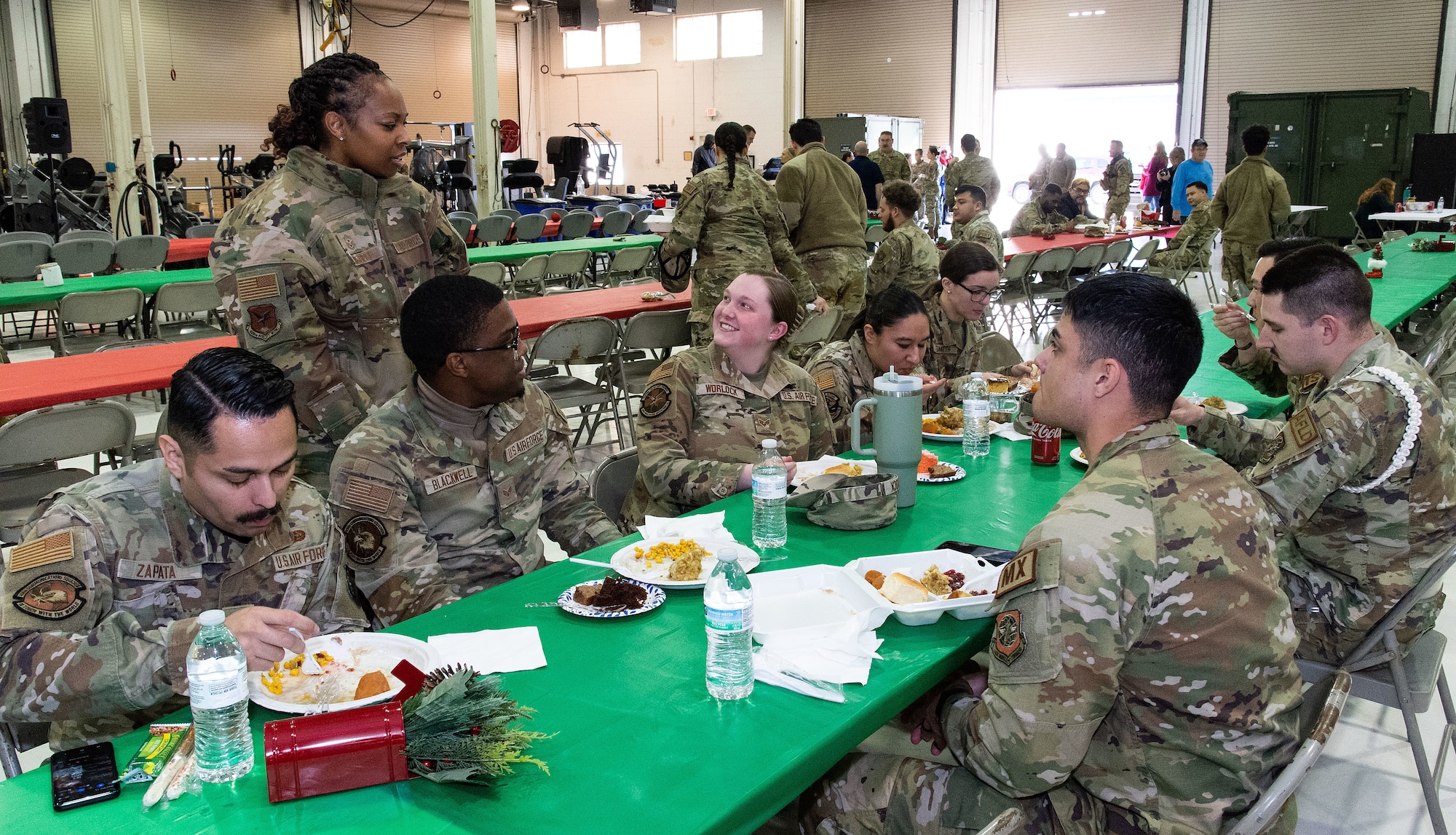 U.S. Air Force Chief Master Sgt. Carolyn Russell, 436th Airlift Wing command chief, visits with Team Dover Airmen during the Operation Feed the Troops meal at Dover Air Force Base, Delaware, Dec. 13, 2023. This year, OFTT volunteers served more than 800 meals to active duty, Reserve and civilians, as well as their family members during two different meals for day and night shift workers (U.S. Air Force photo by Roland Balik)
