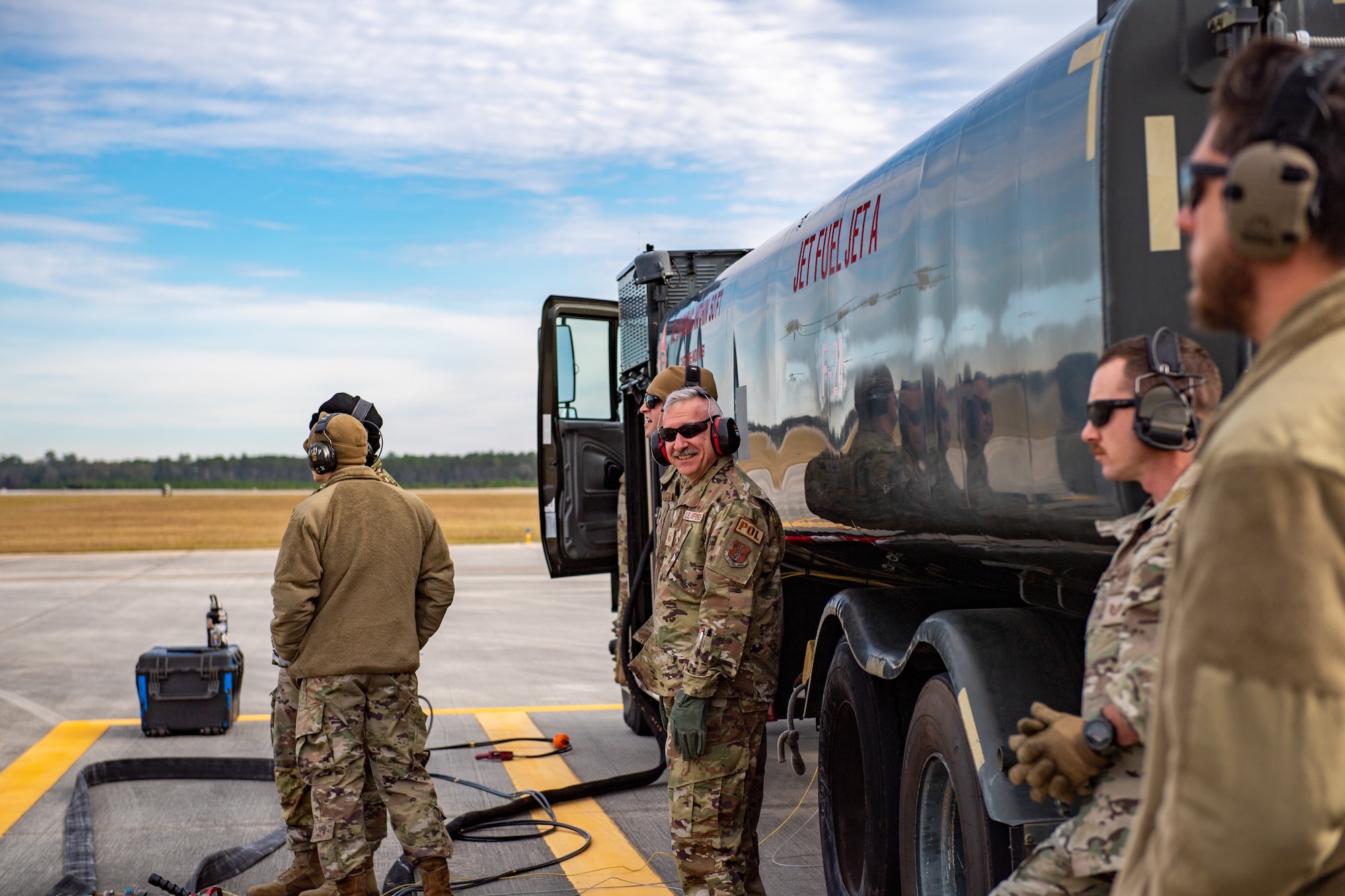 U.S. Air Force Master Sgt. David Smith, 158th Fighter Squadron noncommissioned officer in charge of fuel distribution operations, smiles during a refuel at Moody Air Force Base, Georgia, Dec. 13, 2023. Over three days Smith and five other Guardsmen trained alongside Airmen from Moody AFB to gain insight into fuel operations that support Agile Combat Employment (ACE) concepts. (U.S. Air Force photo by Senior Airman Courtney Sebastianelli)