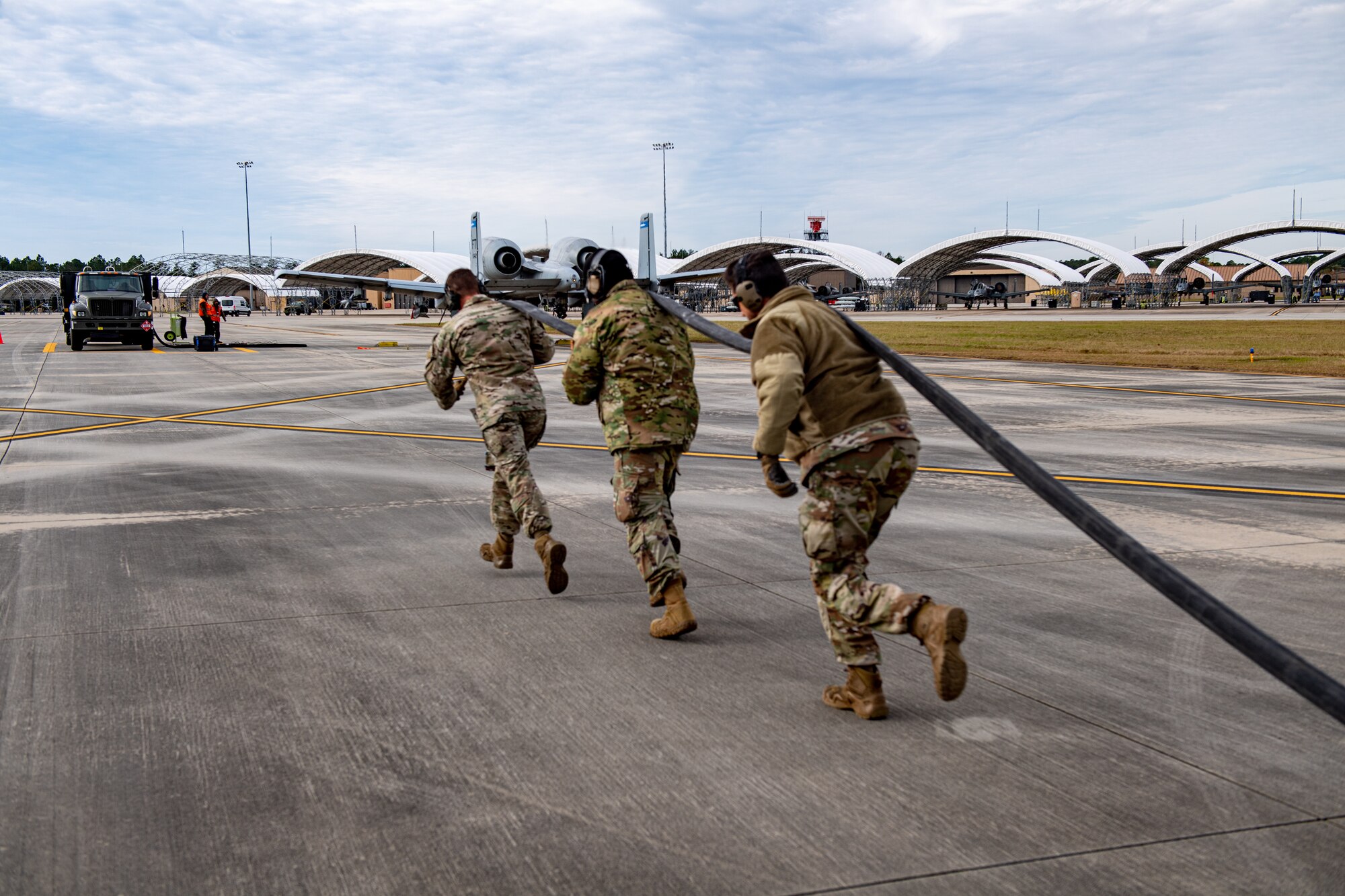 U.S. Air Force Airmen assigned to the 23rd Logistics Readiness Squadron pull a fuel hose during a special fueling operations familiarization training at Moody Air Force Base, Georgia, Dec. 13, 2023. Airmen from Moody trained Guardsmen assigned to the 158th Fighter Squadron on Forward Area Refueling Point (FARP) and the Versatile Integrating Partner Equipment Refueling (VIPER) kit. (U.S. Air Force photo by Senior Airman Courtney Sebastianelli)