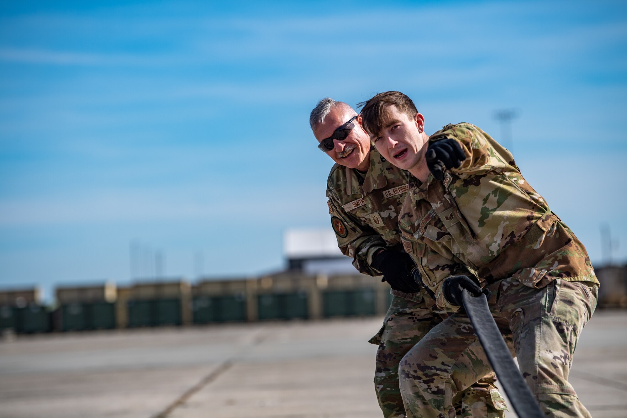 U.S. Air Force Staff Sgt. Tyler Sparks, 23rd Logistics Readiness Squadron forward area refueling point (FARP) team chief, and Master Sgt. David Smith, 158th Fighter Squadron noncommissioned officer in charge of fuel distribution operations, pull a fuel hose during a special fuel operations training at Moody Air Force Base, Georgia, Dec. 12, 2023. Over a period of three days, Airmen from the 23rd LRS trained six Vermont Air National Guardsmen on special fuel operations that support agile combat employment (ACE) concepts. (U.S. Air Force photo by Senior Airman Courtney Sebastianelli)