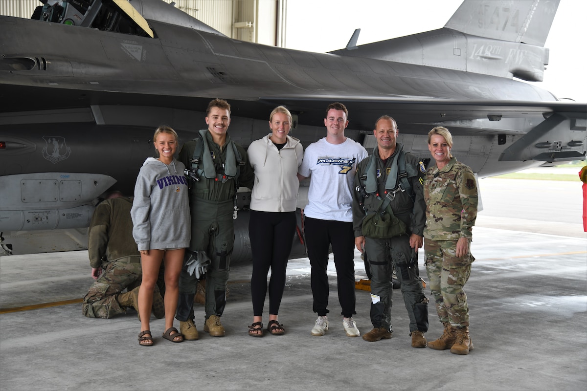 Esko High School Alumni, Senior Airmen Sydney Grayson, Staff Sgt. Logan Grayson, Senior Airman Macy Sunnarborg, Staff Sgt. Caden Erickson, Col. Curt Grayson, and Maj. Jodi Grayson pose for a photo after Staff Sgt. Logan Grayson received an F-16 familiarization flight.