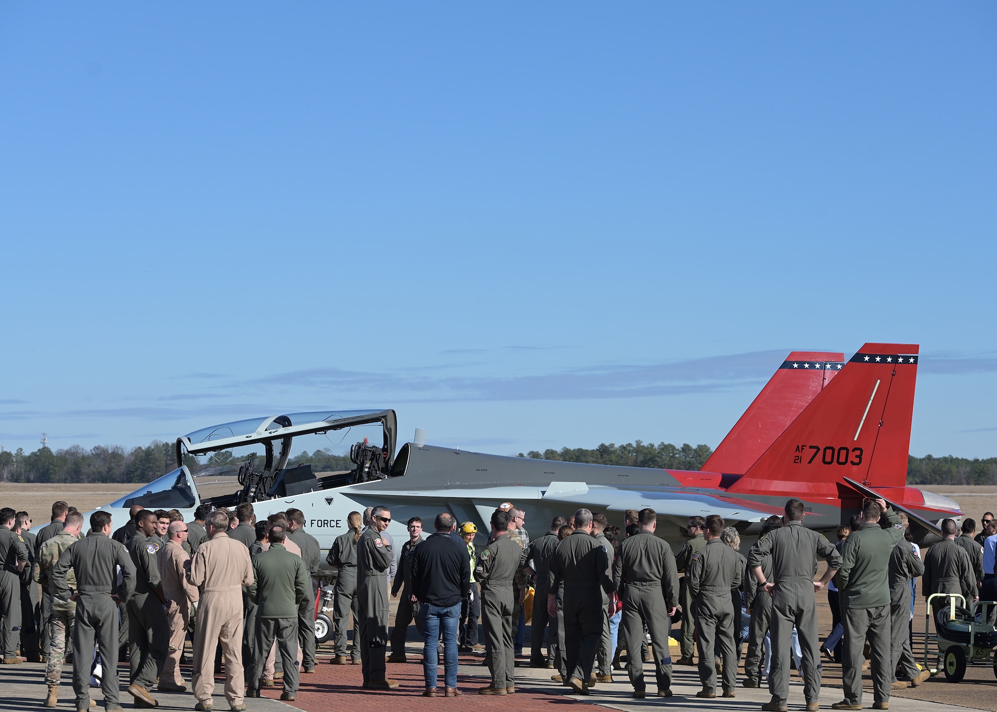 A crowd gathers around the T-7A Red Hawk.