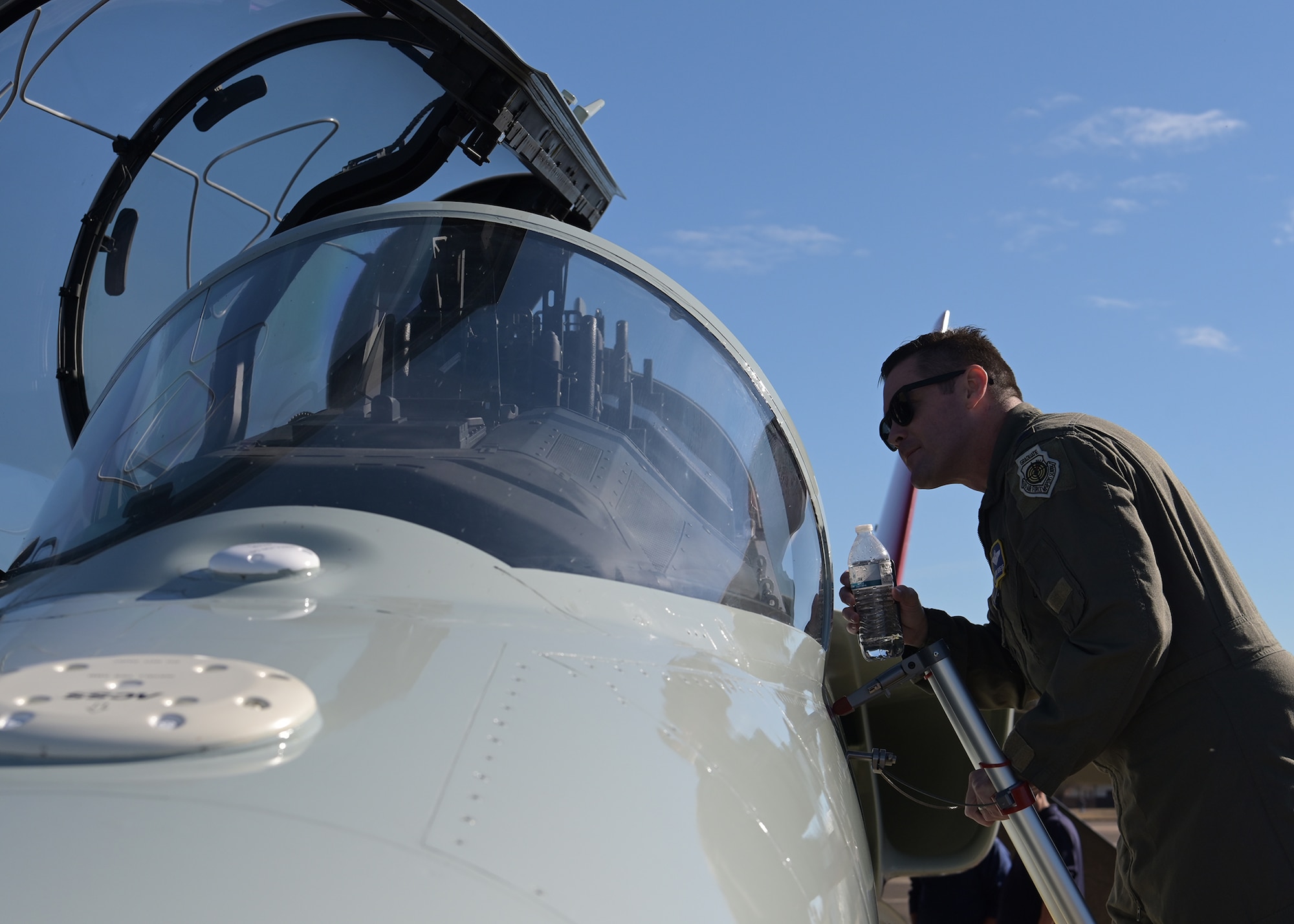 Col. Justin T. Grieve, 14th Flying Training Wing commander, looks into the cockpit of a T-7A Red Hawk.