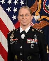 U.S. Army Command Sgt. Maj. Veronica Knapp poses for her official portrait in the Army portrait studio at the Pentagon in Arlington, Va., June 14, 2023. She is in her dark blue Army dress uniform, and behind her is the U.S. Flag and the Army flag. (U.S. Army photo by Leonard Fitzgerald)