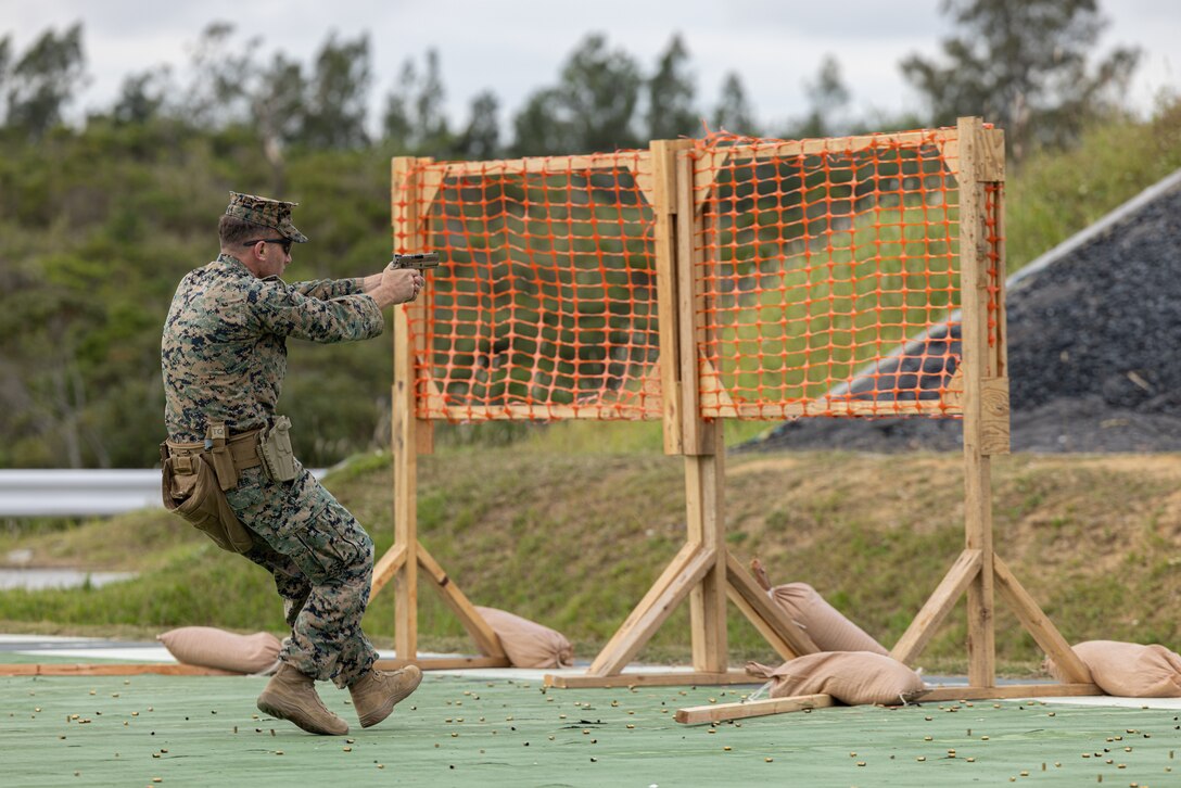 U.S. Marine Corps Maj. Jerrid Procter, an operations officer with Task Force 76/3, 3D Marine Expeditionary Brigade, fires an M18 pistol during the Marine Corps Marksmanship Competition Far East on Camp Hansen, Okinawa, Japan, Dec. 11, 2023. MCMC-Far East is an annual two week event held to improve Marines’ marksmanship, combat readiness and weapon proficiency. Marines utilize the first week to learn various techniques and fundamentals from members of the Marine Corps Shooting Team, and compete the following week as individuals and teams. (U.S. Marine Corps photo by Cpl. Vincent Pham)
