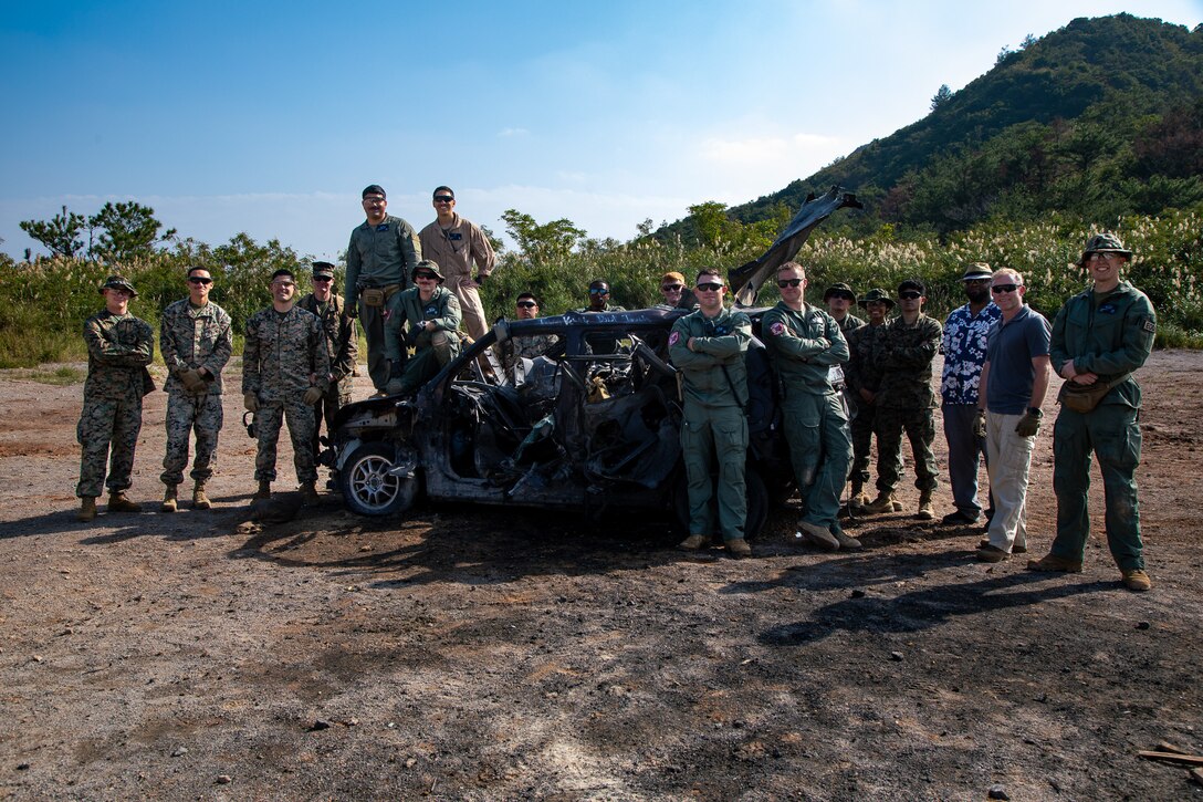 U.S. Marines with Marine Corps Installations Pacific, 1st Marine Air Wing, 3rd Marine Logistics group and honorary guest pose for a photo on Camp Hansen, Okinawa, Japan, Dec. 7 2023. The EOD’s mission is to identify, neutralize and dispose of threats like UXO, improvised explosive devices and weapons of mass destruction, to safeguard operations, installations and personnel in the Pacific region. (U.S. Marine Corps photo by Cpl. Martha Linares)