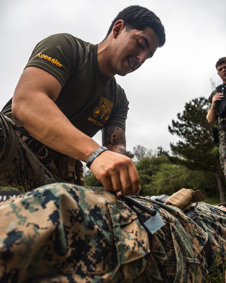 U.S. Marine Corps Cpl. JeanFranco Chiriboga, a correctional specialist liaison with the Provost Marshal's Office, Marine Corps Installations Pacific, teaches a Tactical Combat Casualty Care class during a multiple weapons sustainment range on Camp Hansen, Okinawa, Japan, May. 31, 2023. Motivated by a personal experience of witnessing a medical emergency, Chiriboga pursued extensive medical training and now prioritizes equipping his fellow Marines with life-saving skills, emphasizing the importance of being a supportive pillar in times of crisis. Currently, he has certificates in fast rope techniques, jungle warfare, Marine Corps Martial Arts Instructor, Marine Corps Water Survival Advanced, and Tactical Combat Casualty Care. (U.S. Marine Corps photo by Lance Cpl. Jonathan Beauchamp)