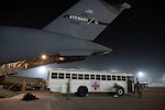 Airmen from the 105th Airlift Wing and 10th Expeditionary Aeromedical Evacuation Flight load patients and bags onto a C-17 Globemaster III at an undisclosed location in the USCENTCOM area of responsibility Nov. 18, 2023. The 105th Airlift Wing spent four months supporting aeromedical evacuation missions out of Ramstein Air Base, Germany.