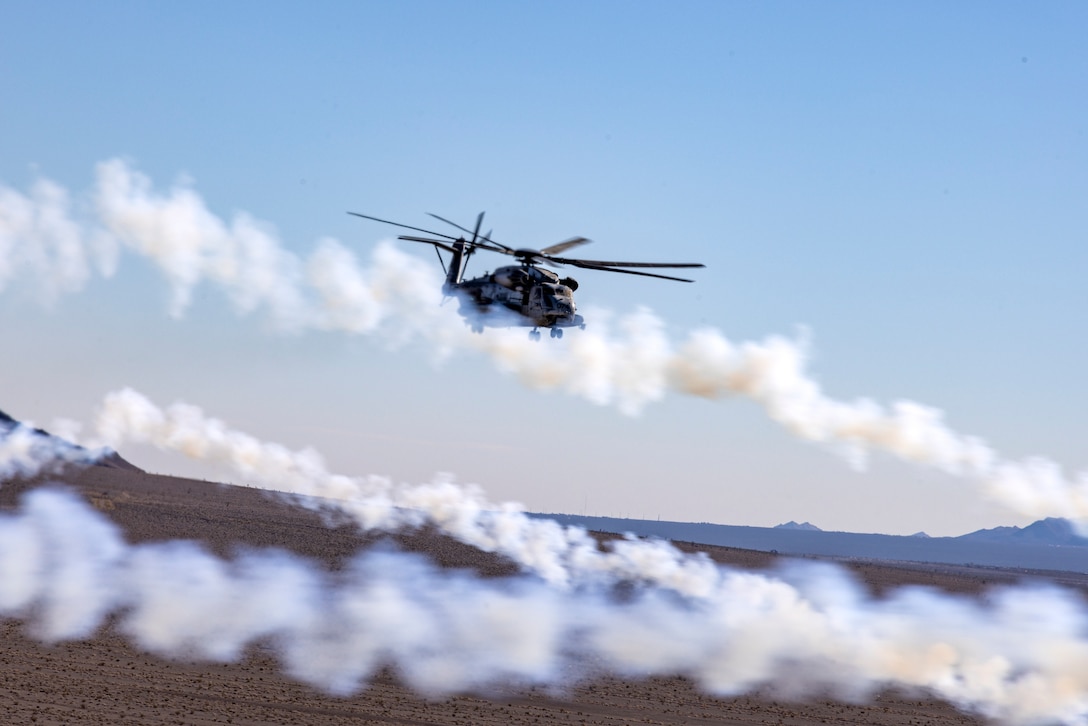 A U.S. Marine Corps CH-53E Super Stallion helicopter with Marine Heavy Helicopter Squadron (HMH) 465, Marine Aircraft Group 16, 3rd Marine Aircraft Wing, conducts evasive maneuver drills during a unit training exercise near Creech Air Force Base, Nevada, Dec. 7, 2023. HMH-465 conducted unit level training to increase core proficiency in evasive maneuvers. (U.S. Marine Corps photo by Lance Cpl. Jackson Rush)