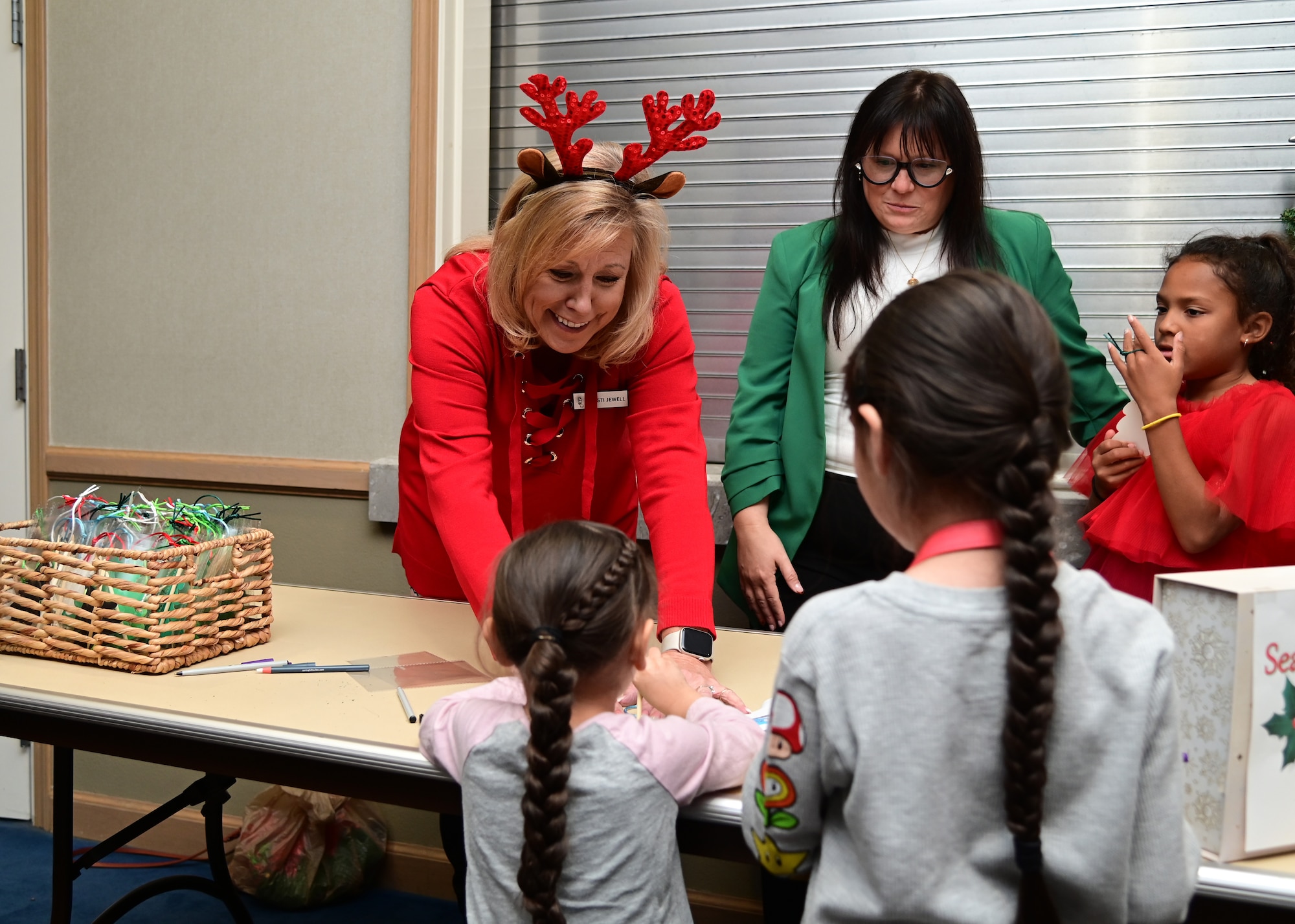 A woman greets a child during a Christmas event.