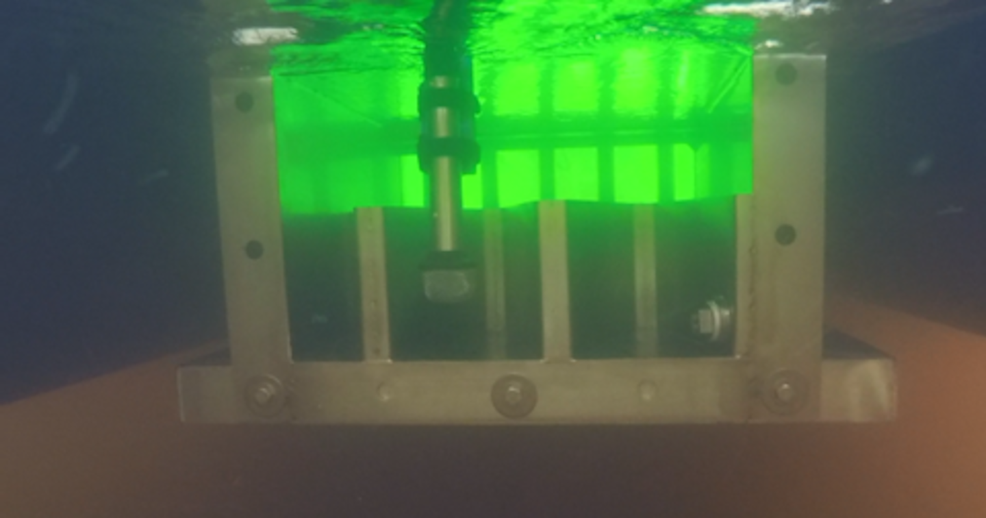 The UV reactor beneath the CyanoSTUN platform (stern side depicted with weir and effluent sampling device).