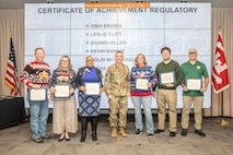 Col. Rhett Blackmon, U.S. Army Corps of Engineers (USACE) Galveston District (SWG) commander, awards member's of SWG's Regulatory Division with a certificate of achievement, Dec. 14, 2023.

Gina Brown, Leslie Clift, Shawn Hillen, Kevin Mannie, Colin McCormack, Tasha Metz, and Kara Vick were recognized for their contributions to planning and executing the annual regulatory outreach event.