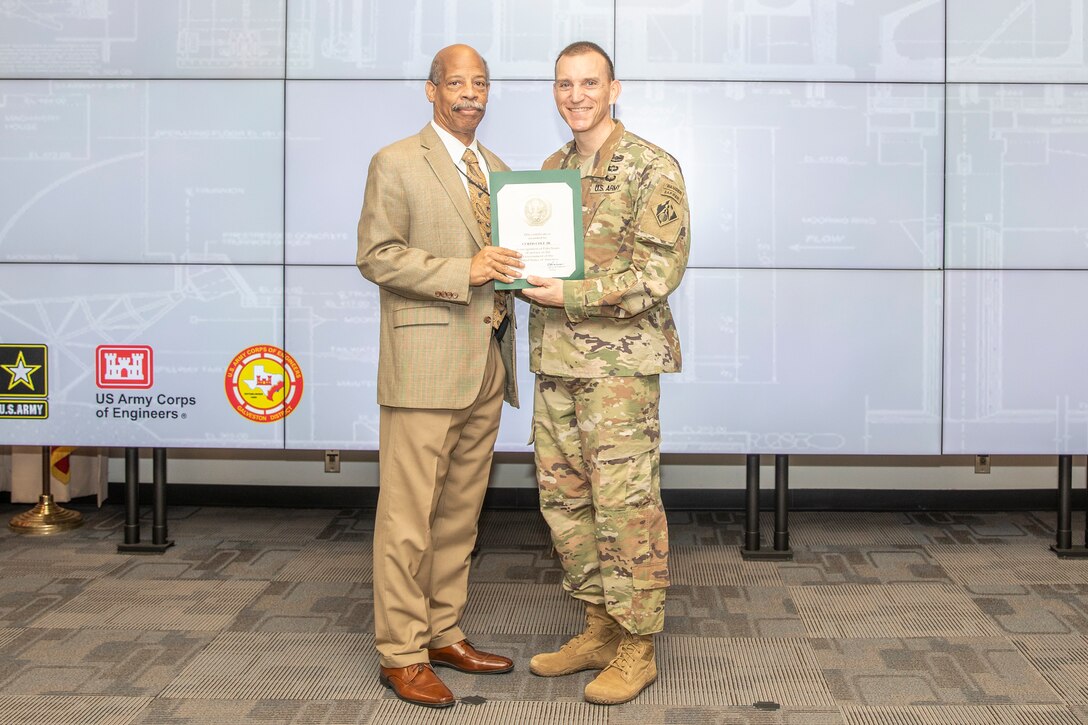 Curtis Cole, Jr., (left) receives a certificate honoring his 50 years of federal government service from Col. Rhett Blackmon during an awards ceremony at the U.S. Army Corps of Engineers (USACE) Galveston District's headquarters, Dec. 14, 2023.