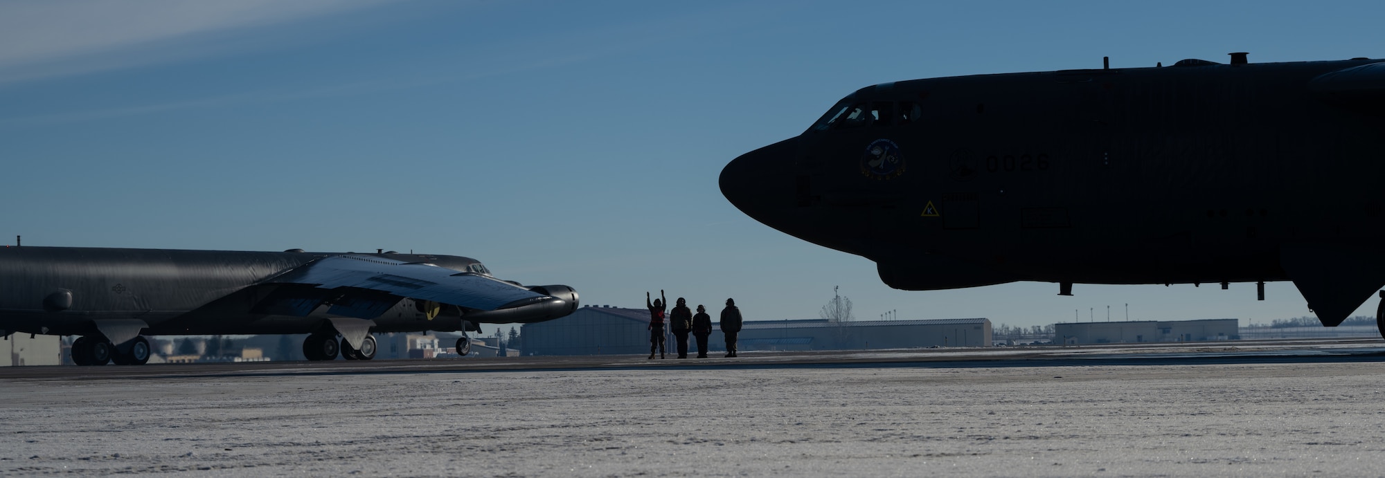 Airmen assigned to the 5th Aircraft Maintenance Squadron usher a B-52H Stratofortress for SURGE Week at Minot Air Force Base, North Dakota, Dec. 13, 2023. SURGE Week allowed the 5th Bomb Wing to aggressively manage its flying hour program. (U.S. Air Force photo by Airman 1st Class Alyssa Bankston)