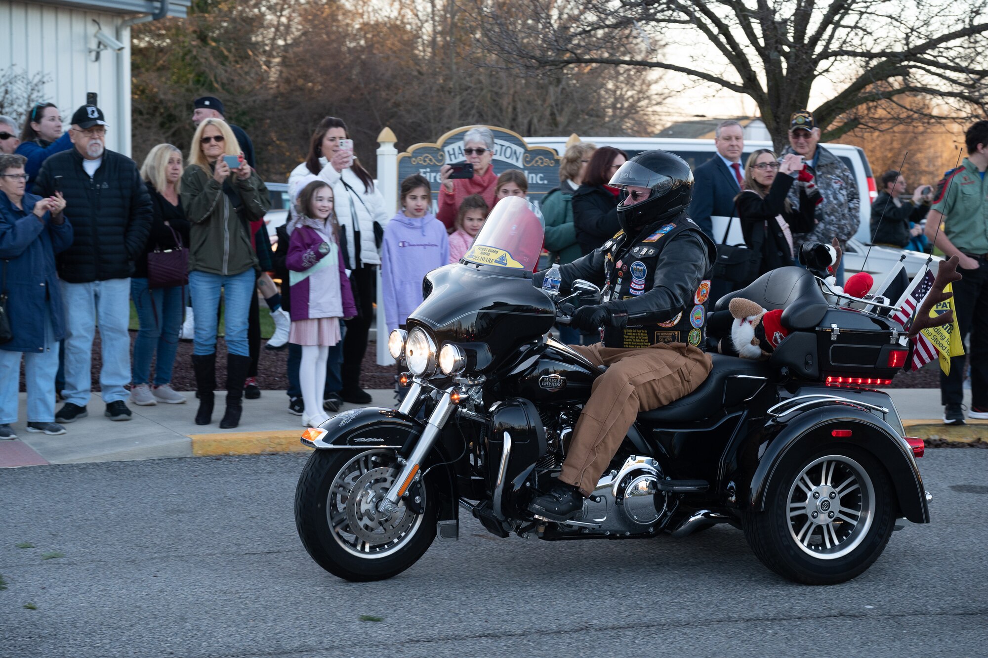 The Wreaths Across America Parade arrives at the Harrington Fire House near Dover Air Force Base, Delaware, Dec. 14, 2023. Members of WAA made an Honor Stop in Harrington, DE for a public memorial service honoring fallen service members. (U.S. Air Force photo by Mauricio Campino)