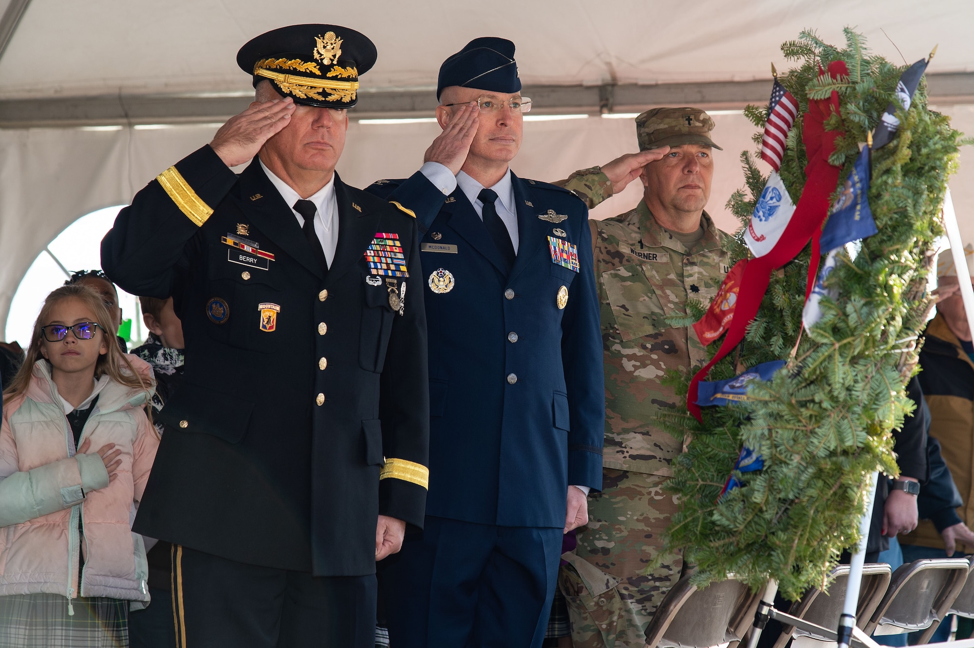 U.S. Air Force Col. Chris McDonald, center, 436th Airlift Wing commander, Delaware National Guard Maj. Gen. Michael Berry, right, Adjutant General, New Castle, Delaware, and Delaware National Guard Chaplain (Lt. Col.) Andrew Werner, right salute during the national anthem at the Wreaths Across America ceremony held at Legislative Hall, Dover, Delaware, Dec. 11, 2023. McDonald, Berry, and Werner were guest speakers at the ceremony. (U.S. Air Force photo by Roland Balik)