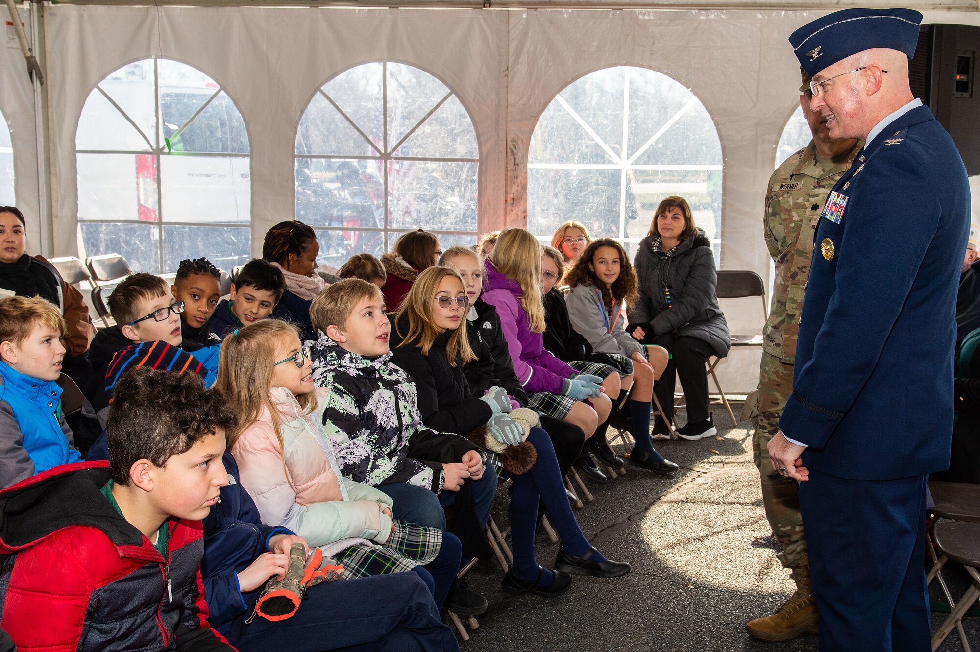 U.S. Air Force Col. Chris McDonald, center, 436th Airlift Wing commander, speaks with Holy Cross Elementary School fourth-grade students before the Wreaths Across America ceremony at Legislative Hall, Dover, Delaware, Dec. 11, 2023. McDonald represented Dover Air Force Base at the event, as the Delaware General Assembly welcomed WAA to the First State. National WAA Day is Dec. 16. (U.S. Air Force photo by Roland Balik)
