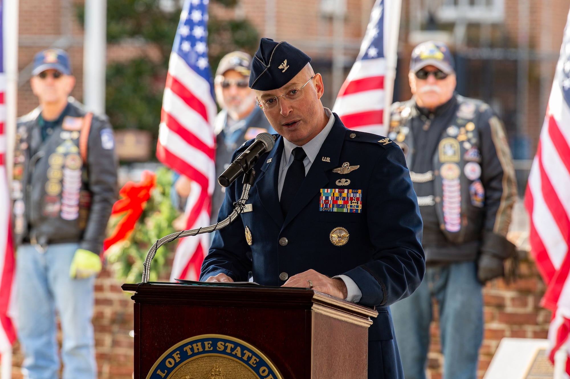 U.S. Air Force Col. Chris McDonald, 436th Airlift Wing commander, addresses attendees during the Wreaths Across America ceremony at Legislative Hall, Dover, Delaware, Dec. 11, 2023. McDonald represented Dover Air Force Base at the event as the Delaware General Assembly welcomed WAA to the First State. National WAA Day is Dec. 16. (U.S. Air Force photo by Roland Balik)