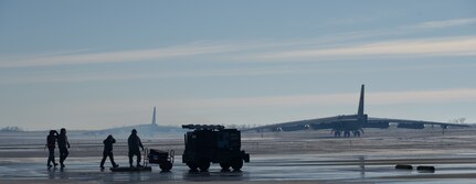 Airmen assigned to the 5th Aircraft Maintenance Squadron walk on the flight line at Minot Air Force Base, North Dakota, Dec. 13, 2023. The 5th Bomb Wing was able to successfully showcase its airpower and high-speed deterrence mission set by being able to launch multiple aircraft in a short amount of time. (U.S. Air Force photo by Airman 1st Class Alyssa Bankston)