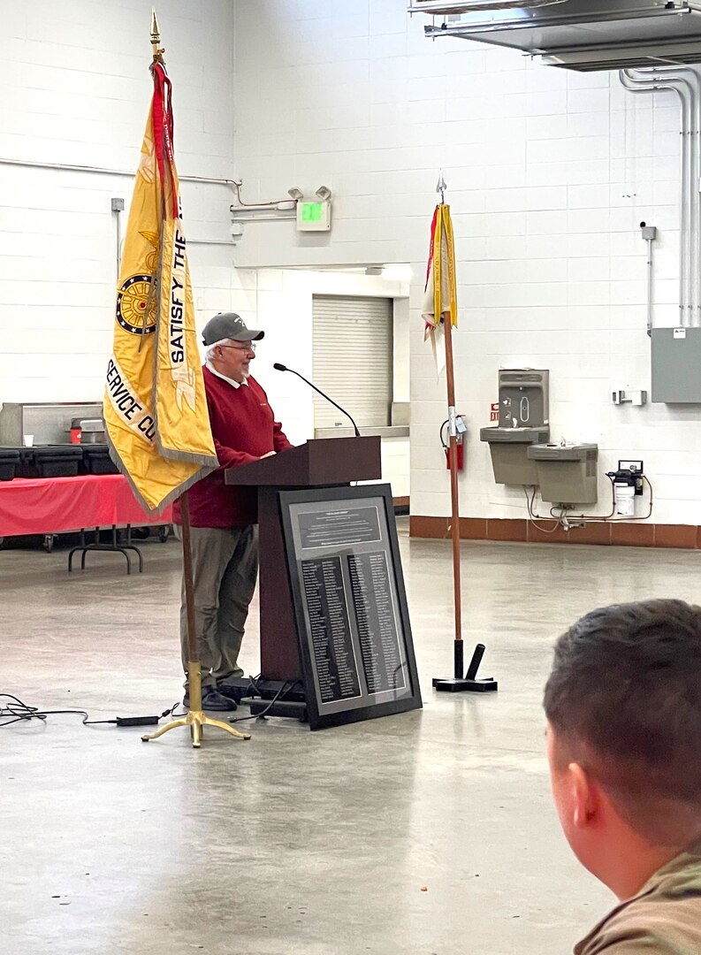 Jerry Roush, a Vietnam Veteran from the Illinois Army National Guard's 126th Supply and Services Co., speaks to the modern 126th Quartermaster Co. on Dec. 17 as part of the unit's family holiday party.