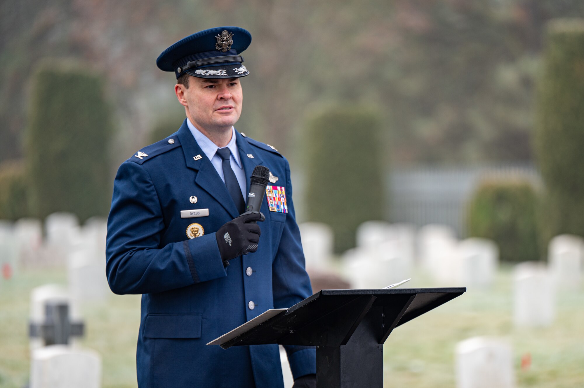 An Air Force colonel speaks at a podium