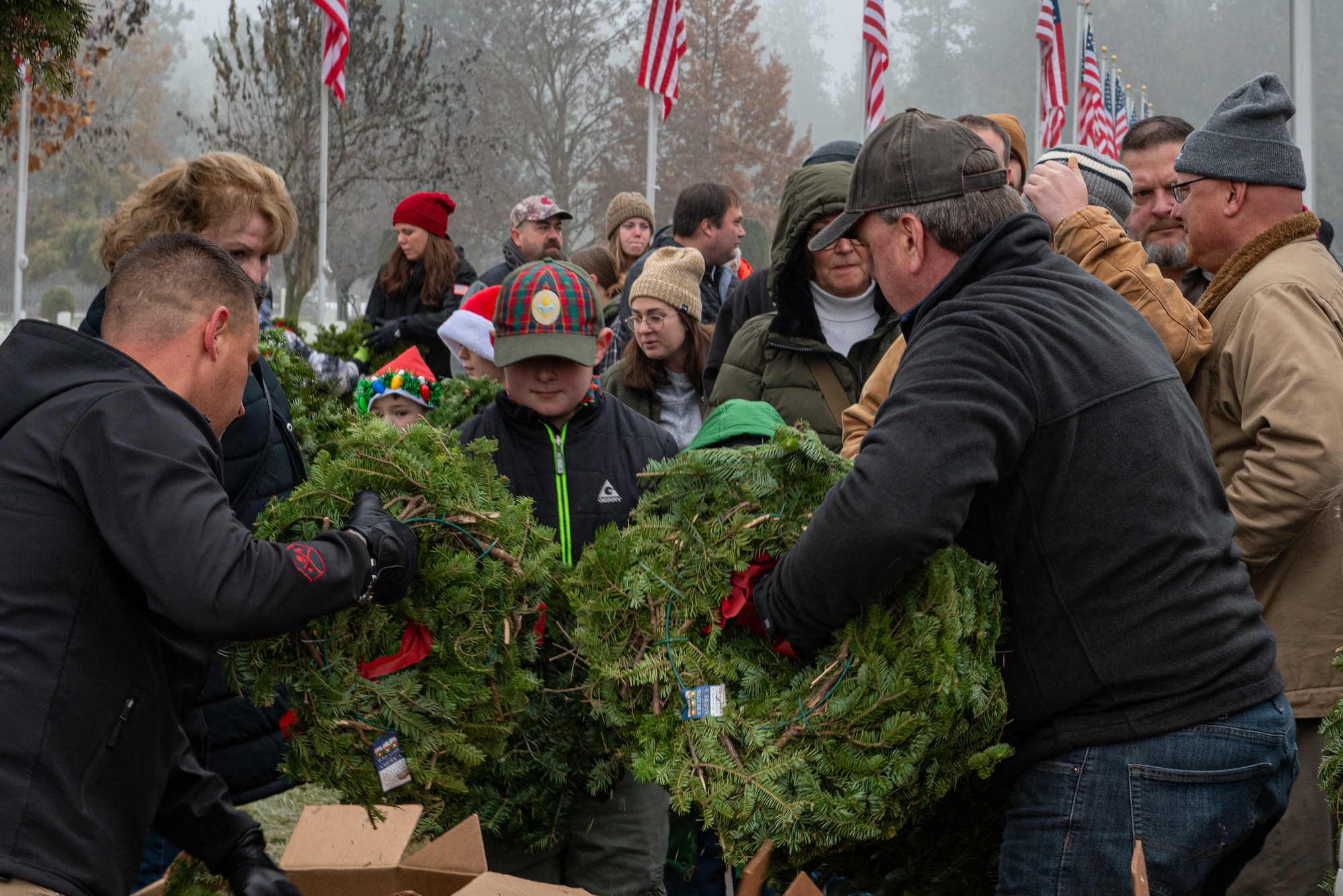 A group of people carrying wreaths
