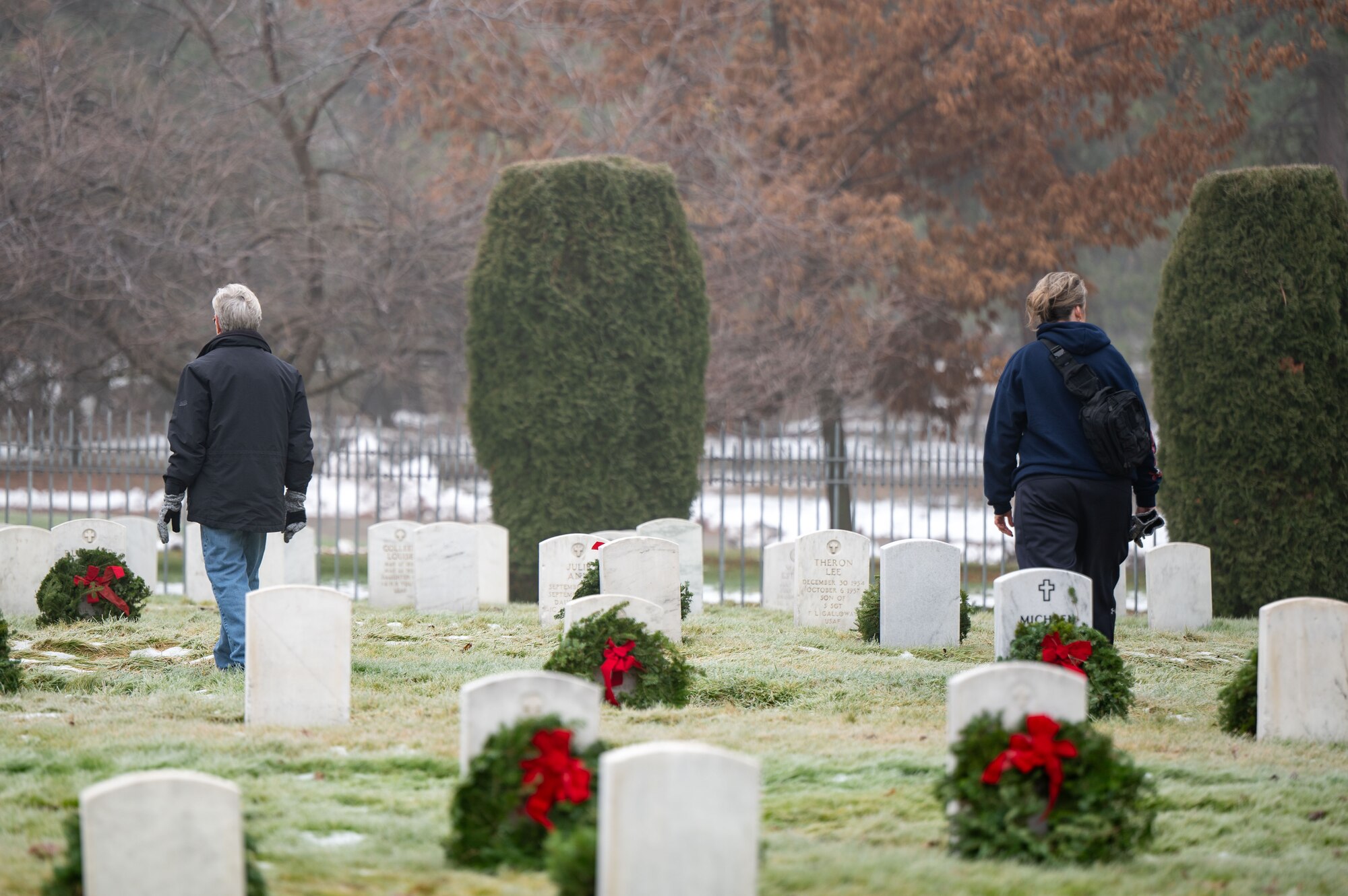 Two people walking in a cemetery