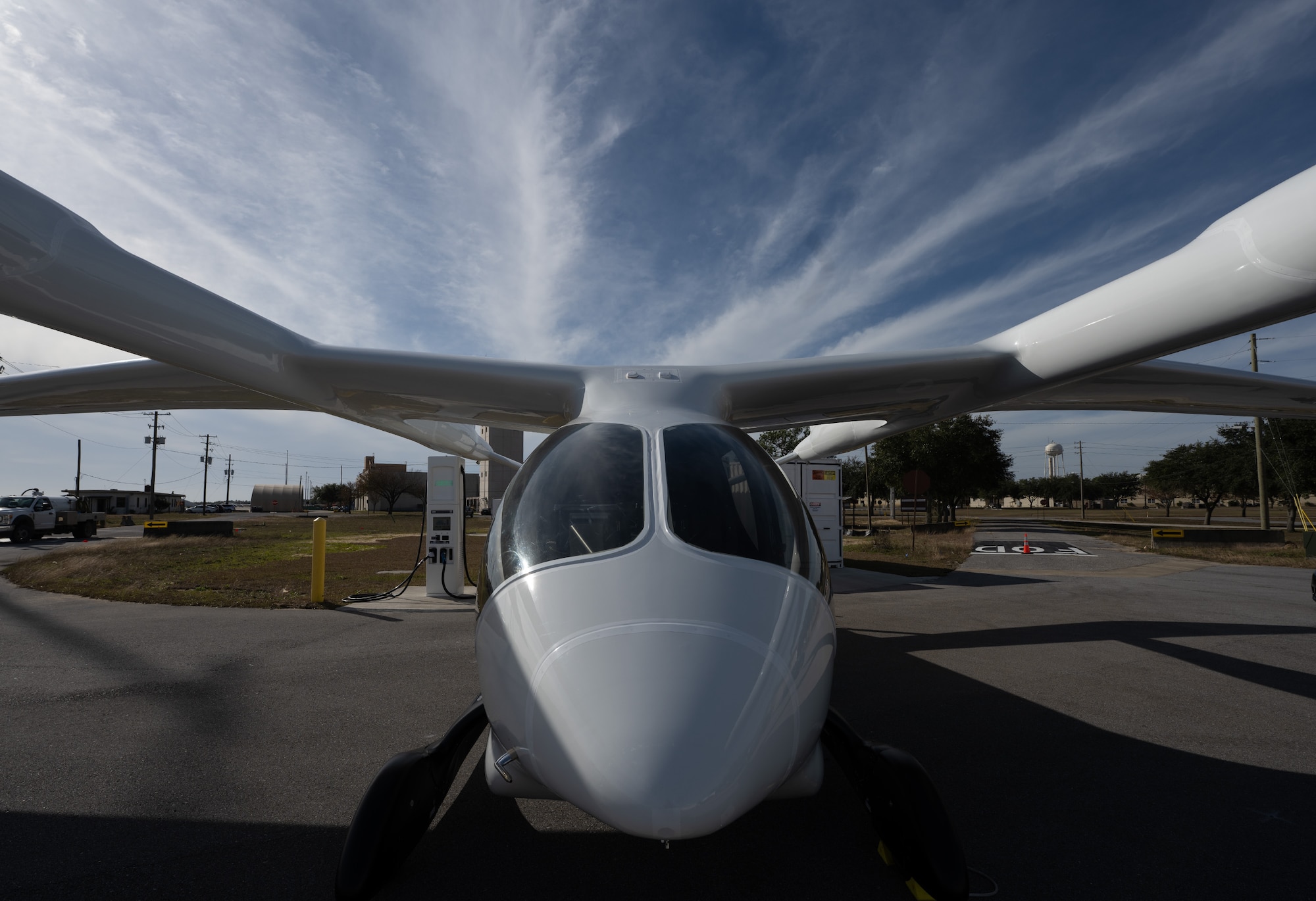 An electric aircraft rests on the flight line.