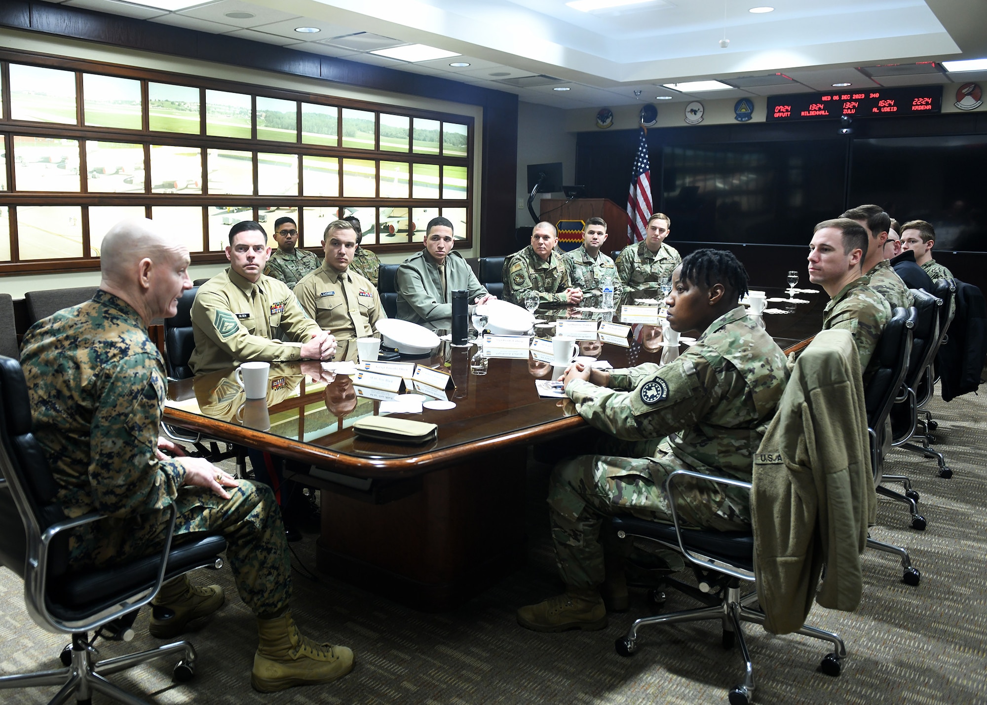 uniformed personnel sitting around a conference table.