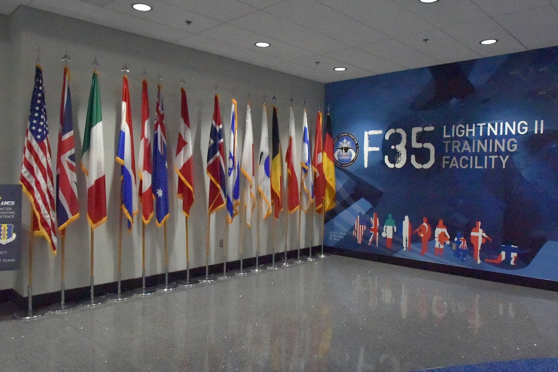 Flags are displayed along a wall at the F-35 schoolhouse on Eglin AFB, Florida.