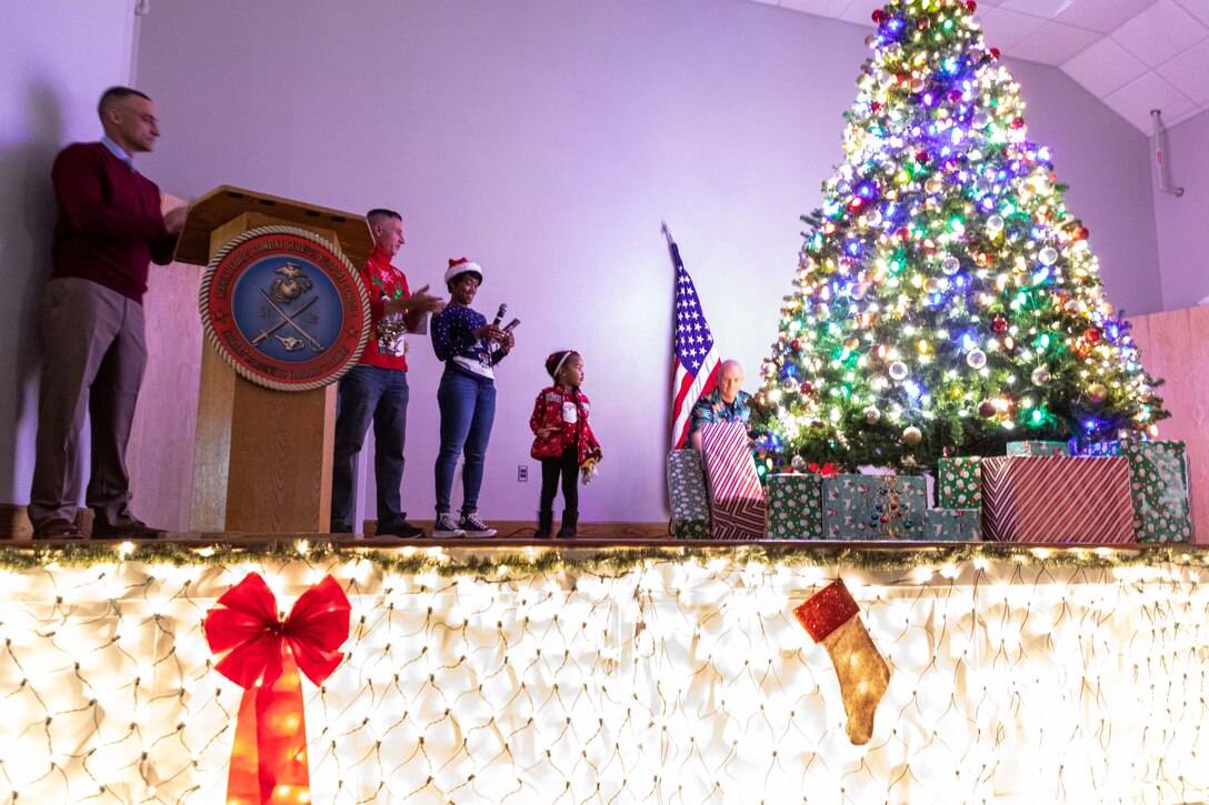 U.S. Marine Corps Col. Marshalee Clarke, commanding officer of Marine Corps Combat Service Support Schools, turns on lights wrapped around a Christmas tree during a tree lighting ceremony at Camp Gilbert H. Johnson, North Carolina, Dec. 1, 2023. MCCSSS hosted a tree lighting ceremony to allow students, staff, and families to experience the holiday season as a community and spread holiday cheer. (U.S. Marine Corps photo by Lance Cpl. Zachary Candiani)