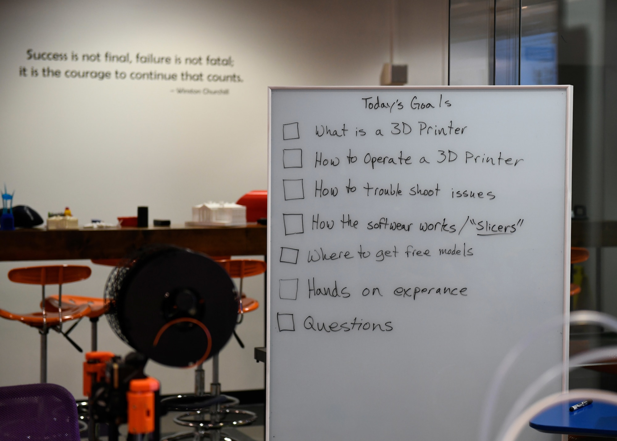 A whiteboard displays tasks for a 3D printing class at Joint Base Andrews, Md., Dec. 1, 2023.