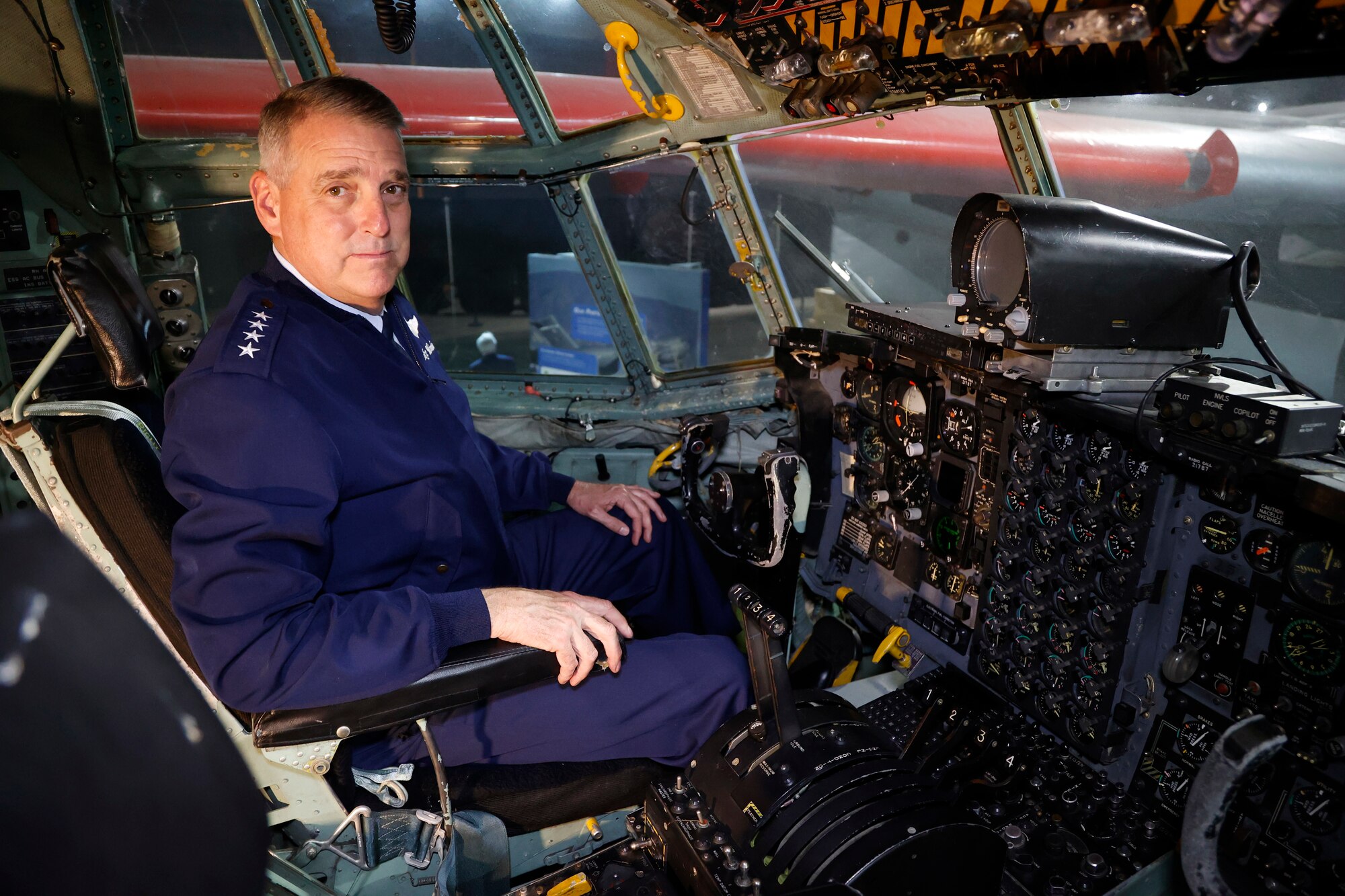 General Mike Minihan sits in the cockpit of the C-130E on display in the Global Reach Gallery. Gen. Minihan flew this aircraft to the museum for its final flight in 2011.