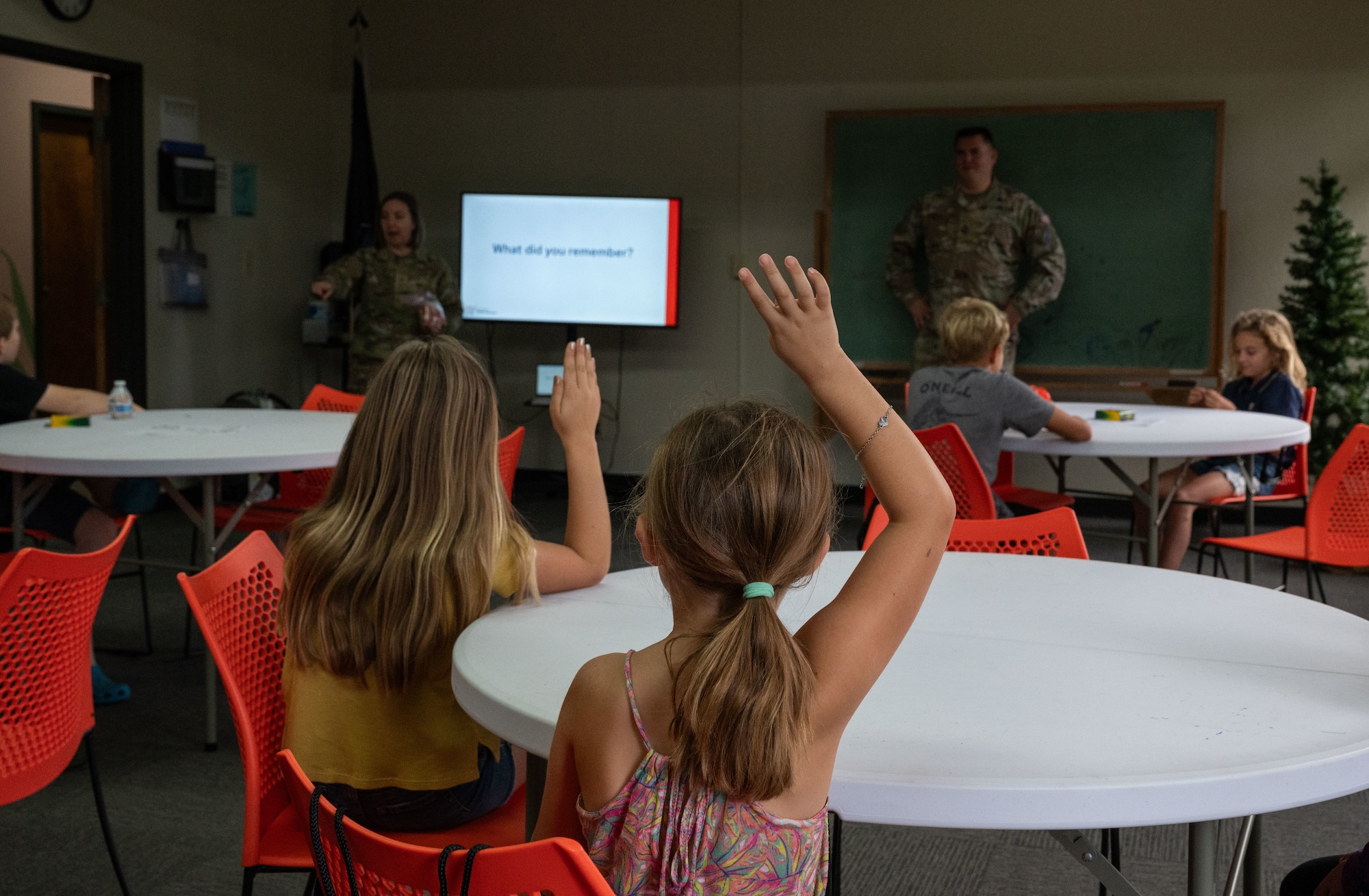 Students raise their hands to answer a question during a Science, Technology, Engineering and Mathematics (STEM) to Space event hosted by Guardians from U.S. Space Forces Indo-Pacific for home school educators and students from around the island of Oahu, Honolulu, Hawaii, December 15, 2023. STEM to Space was designed to facilitate virtual connections between Space Force Guardians and students to share the importance to STEM careers related to space. Students learned about how the Space Force contributed to national security and the daily life around the United States. (U.S. Air Force photo by Tech. Sgt. Hailey Haux)
