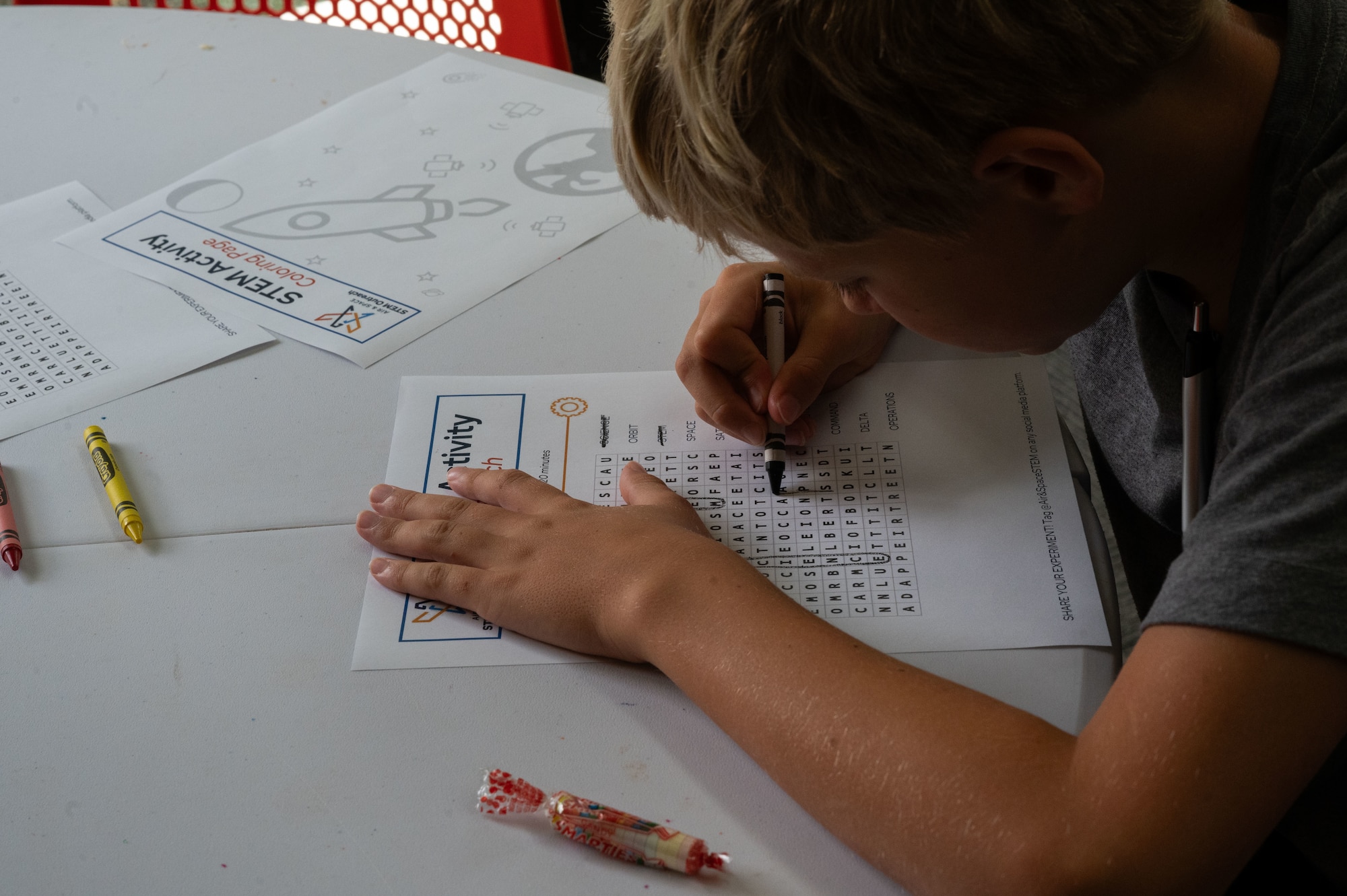 A student works on a word search puzzle during a Science, Technology, Engineering and Mathematics (STEM) to Space event hosted by Guardians from U.S. Space Forces Indo-Pacific for home school educators and students from around the island of Oahu, Honolulu, Hawaii, December 15, 2023. The event was in celebration of the Space Force’s fourth anniversary. STEM to Space was designed to facilitate virtual connections between Space Force Guardians and students to share the importance to STEM careers related to space. (U.S. Air Force photo by Tech. Sgt. Hailey Haux)