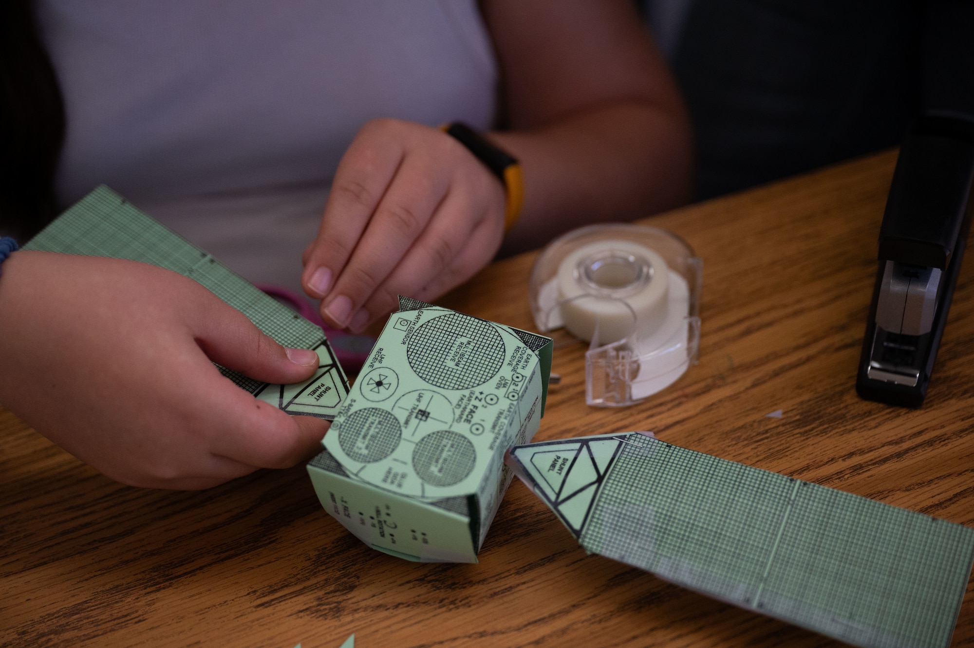 A student works on creating a mini satellite during a Science, Technology, Engineering and Mathematics (STEM) to Space event hosted by Guardians from U.S. Space Forces Indo-Pacific for home school educators and students from around the island of Oahu, Honolulu, Hawaii, December 15, 2023. STEM to Space was designed to facilitate virtual connections between Space Force Guardians and students to share the importance to STEM careers related to space. Students learned about how the Space Force contributed to national security and the daily life around the United States. (U.S. Air Force photo by Tech. Sgt. Hailey Haux)