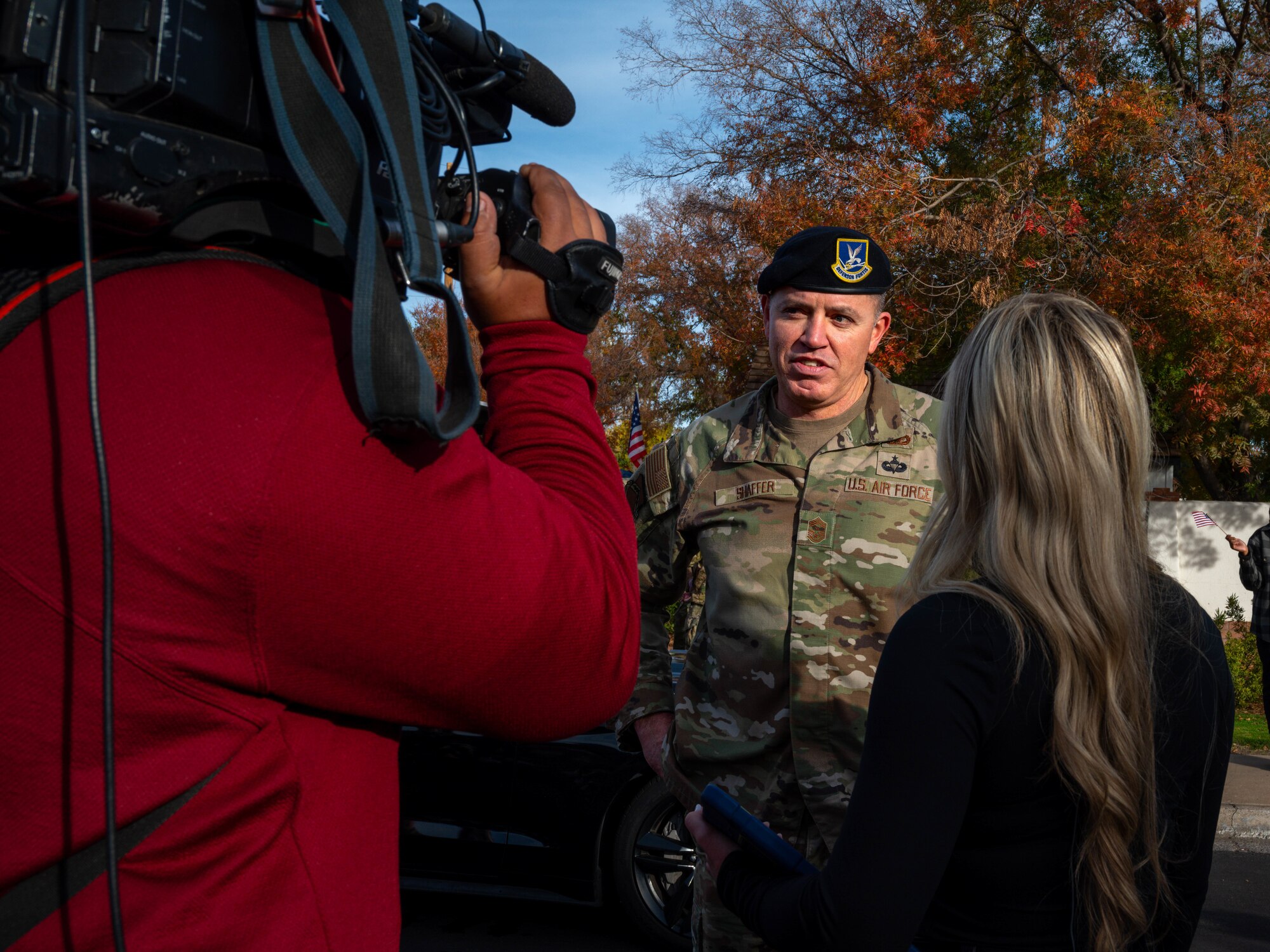 U.S. Air Force Chief Master Sgt. Jason Shaffer, 56th Fighter Wing command chief, speaks with local news channel representatives at the Fiesta Bowl Parade, Dec. 16, 2023, in Phoenix, Arizona.